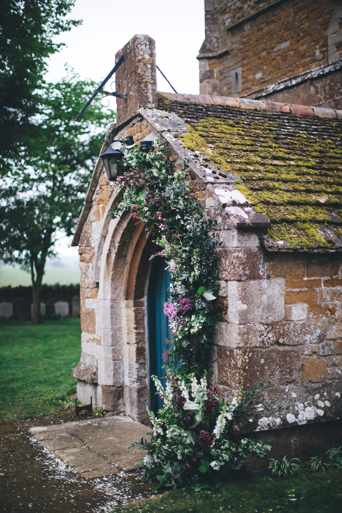 Entrance of a church with a tall floral decoration surrounding the doorway