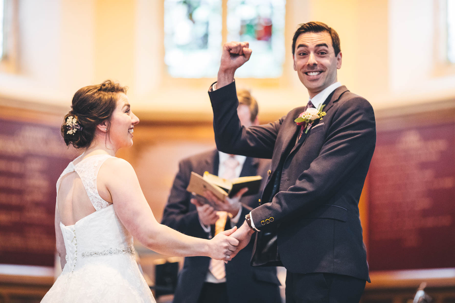 groom fist pumps the air after getting married