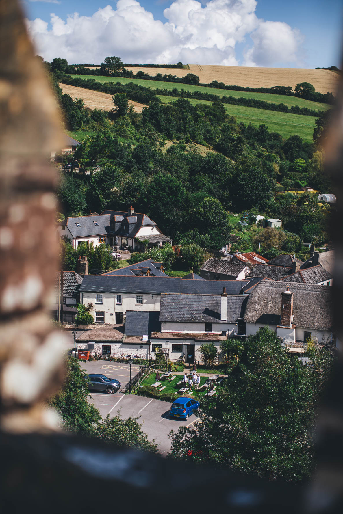 Rolling hillside in a Devonshire village taken from the top of a church looking down over the buildings in the village