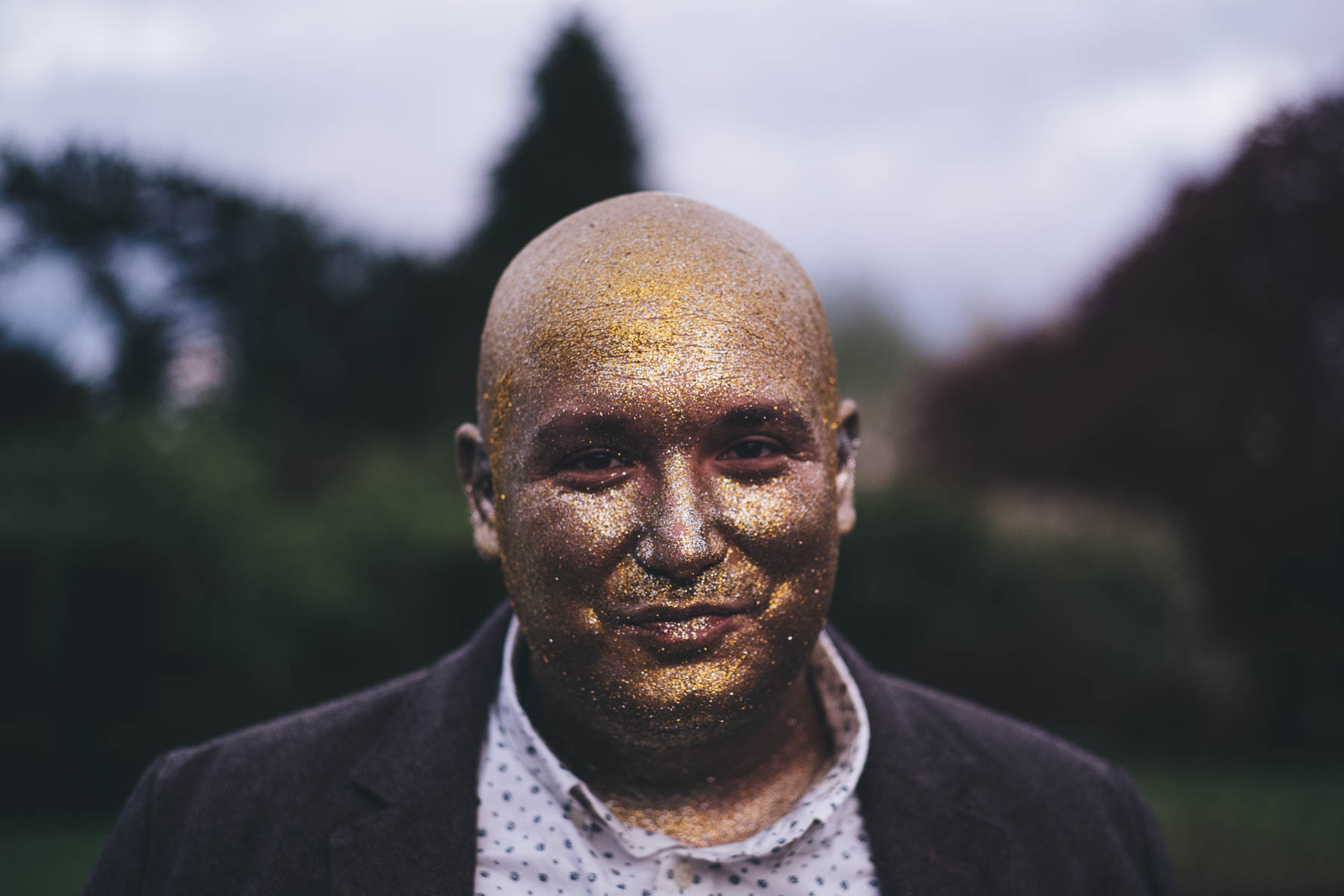 man with whole face painted in glitter