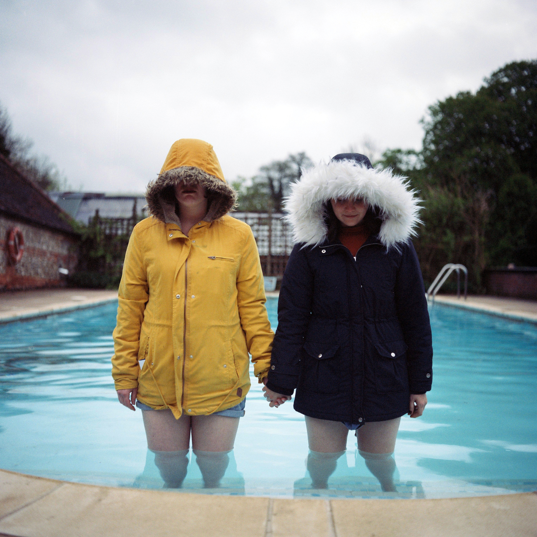 just casually standing in coats in a swimming pool