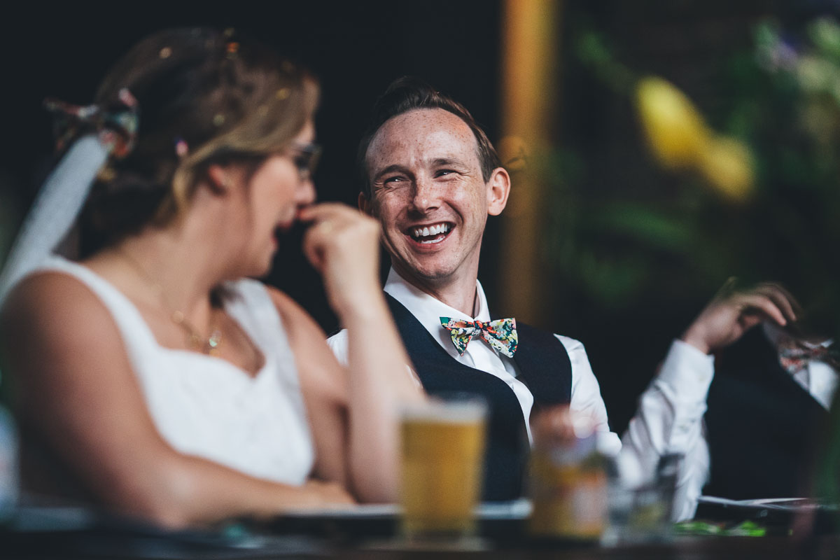 groom laughing during the speeches