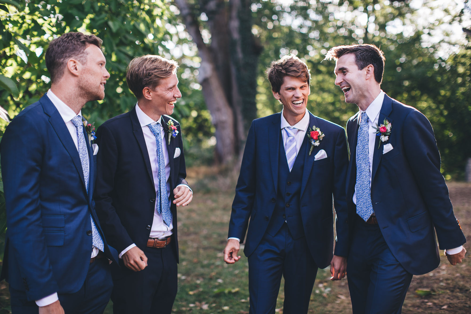 groom laughs with his groomsmen