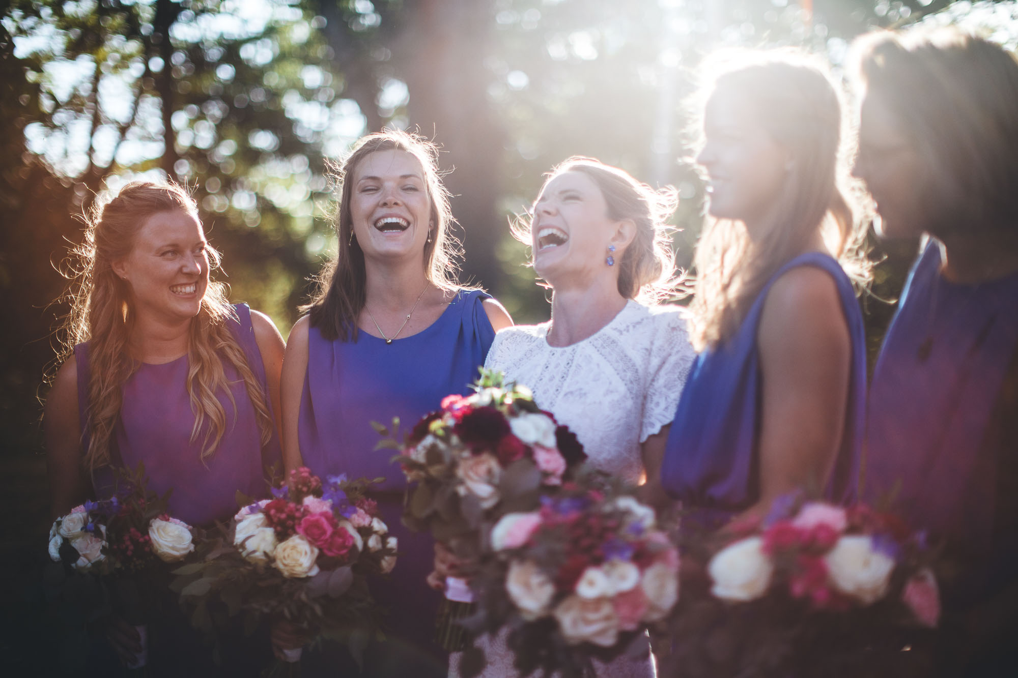 bride laughs with bridesmaids
