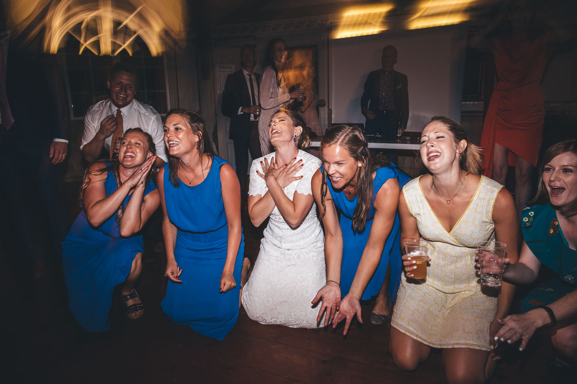 Louise and her bridesmaid on the floor dancing with their arms crossed
