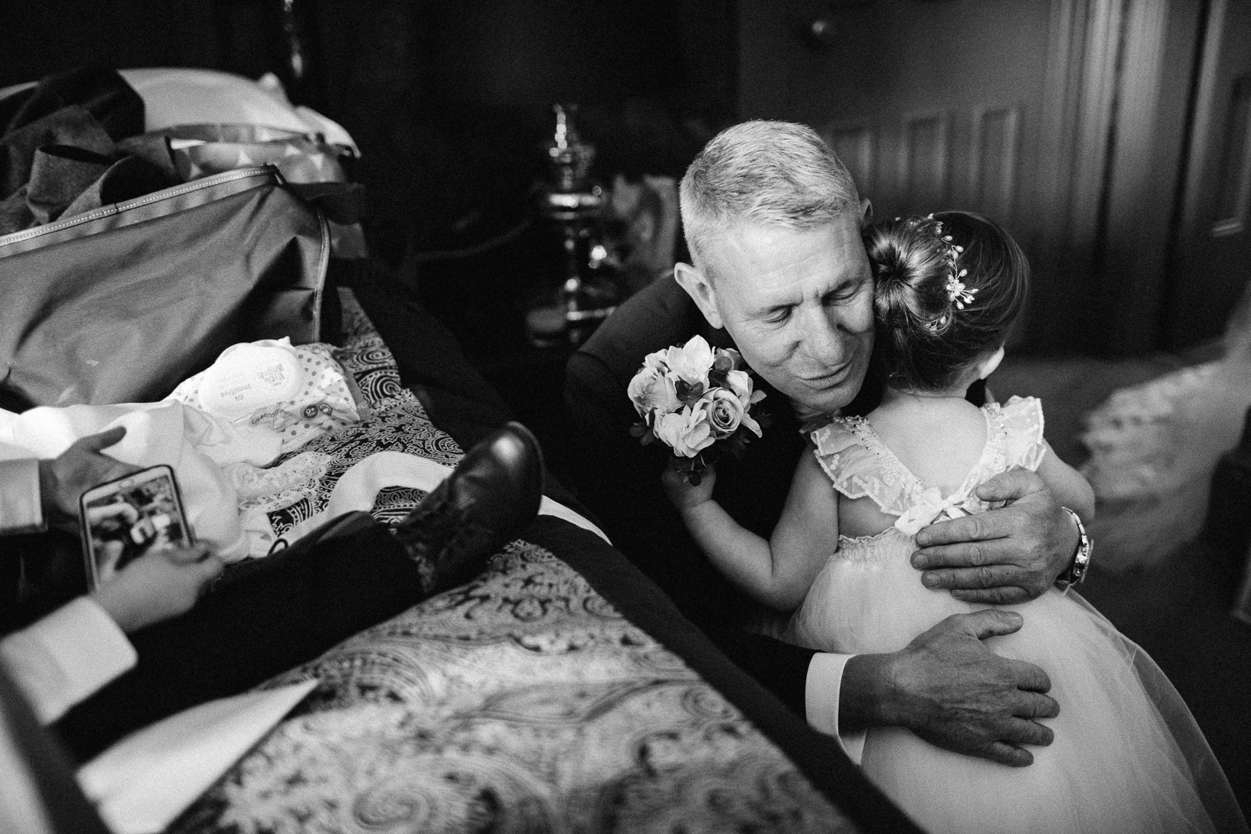 grandfather hugs little flower girl