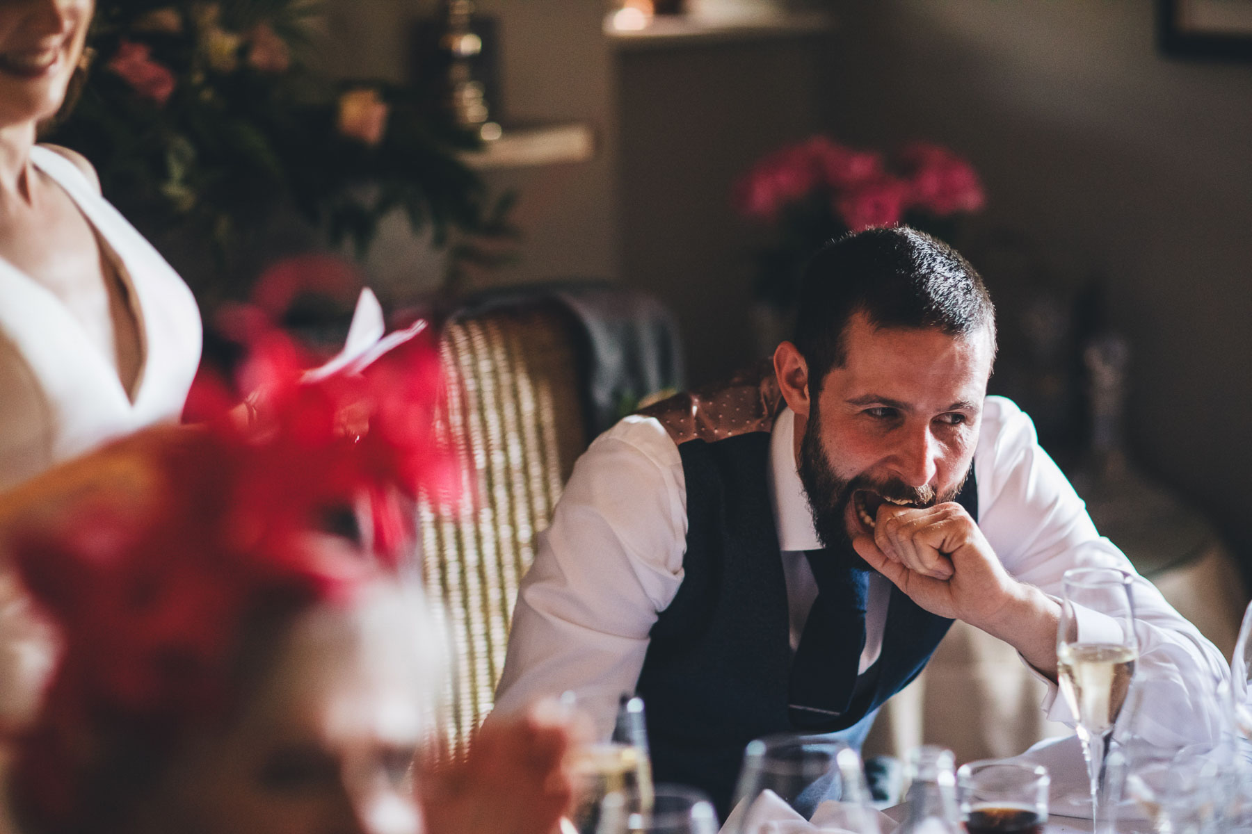 groom bites his knuckle during his brides speech