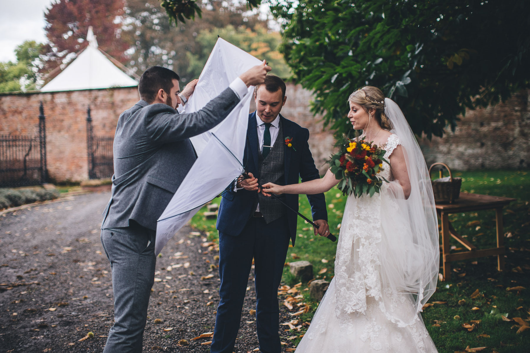 umbrella turns inside out on bride and groom