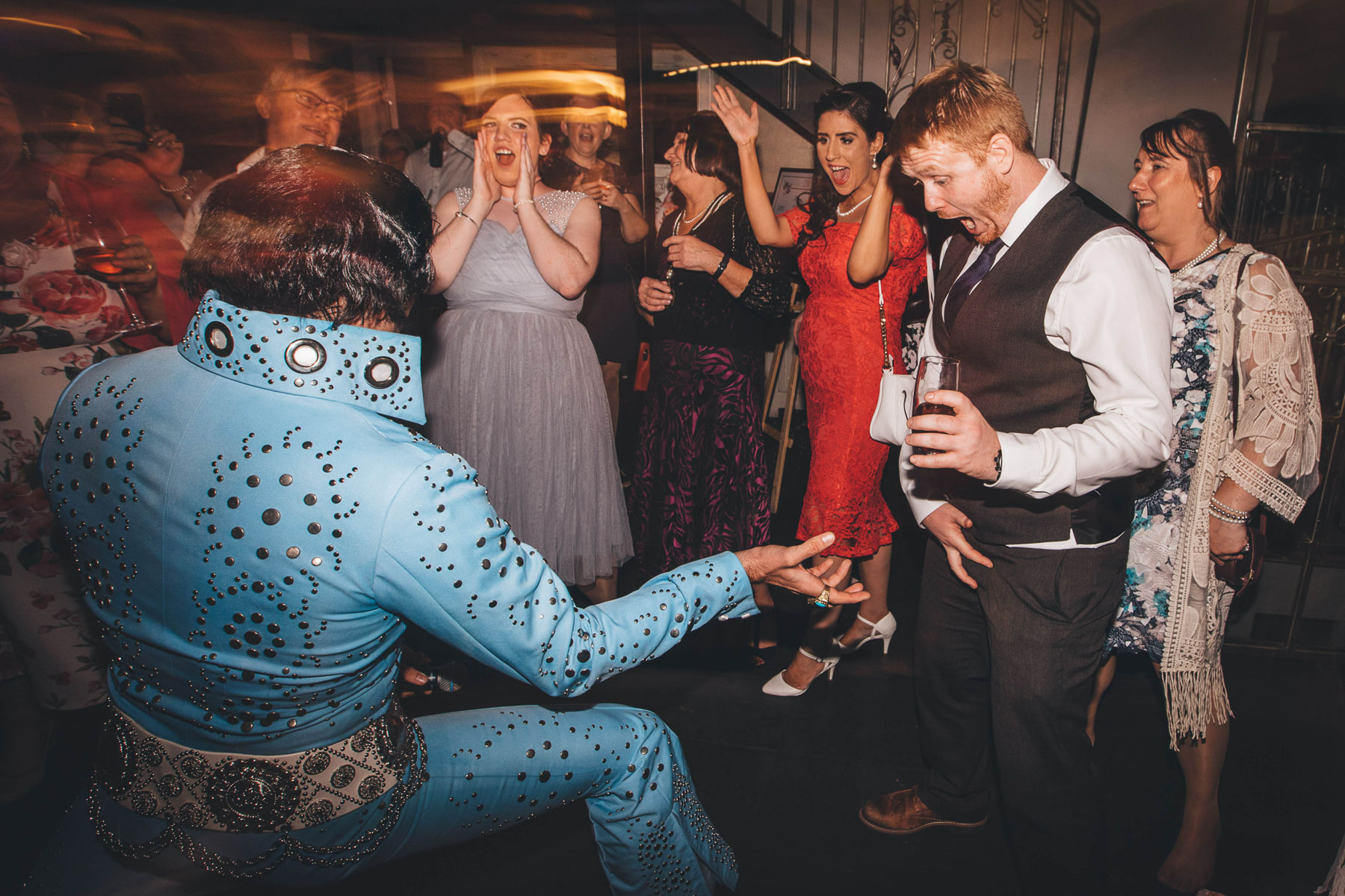 elvis goes to grope a guest during the wedding reception in a very funny moment