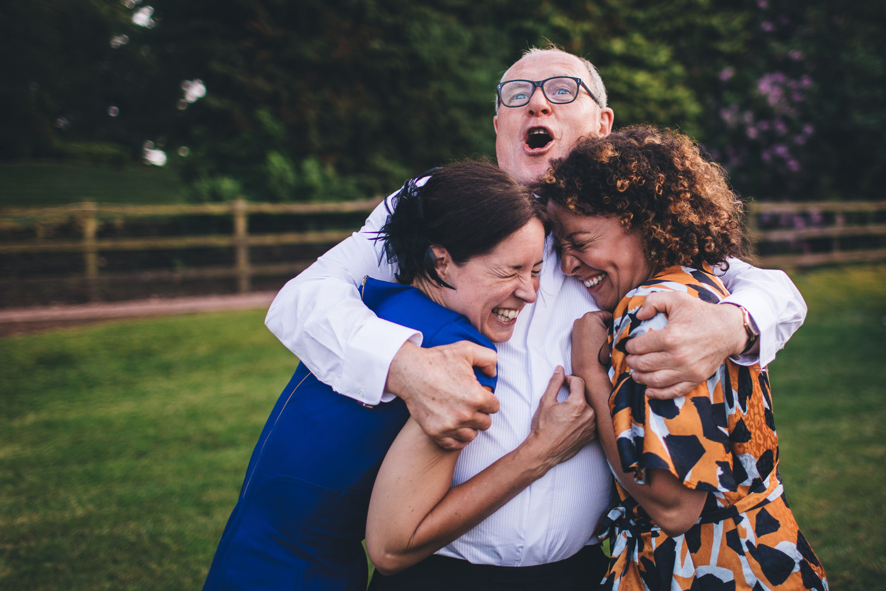 dad holds girls in tight loving but funny embrace