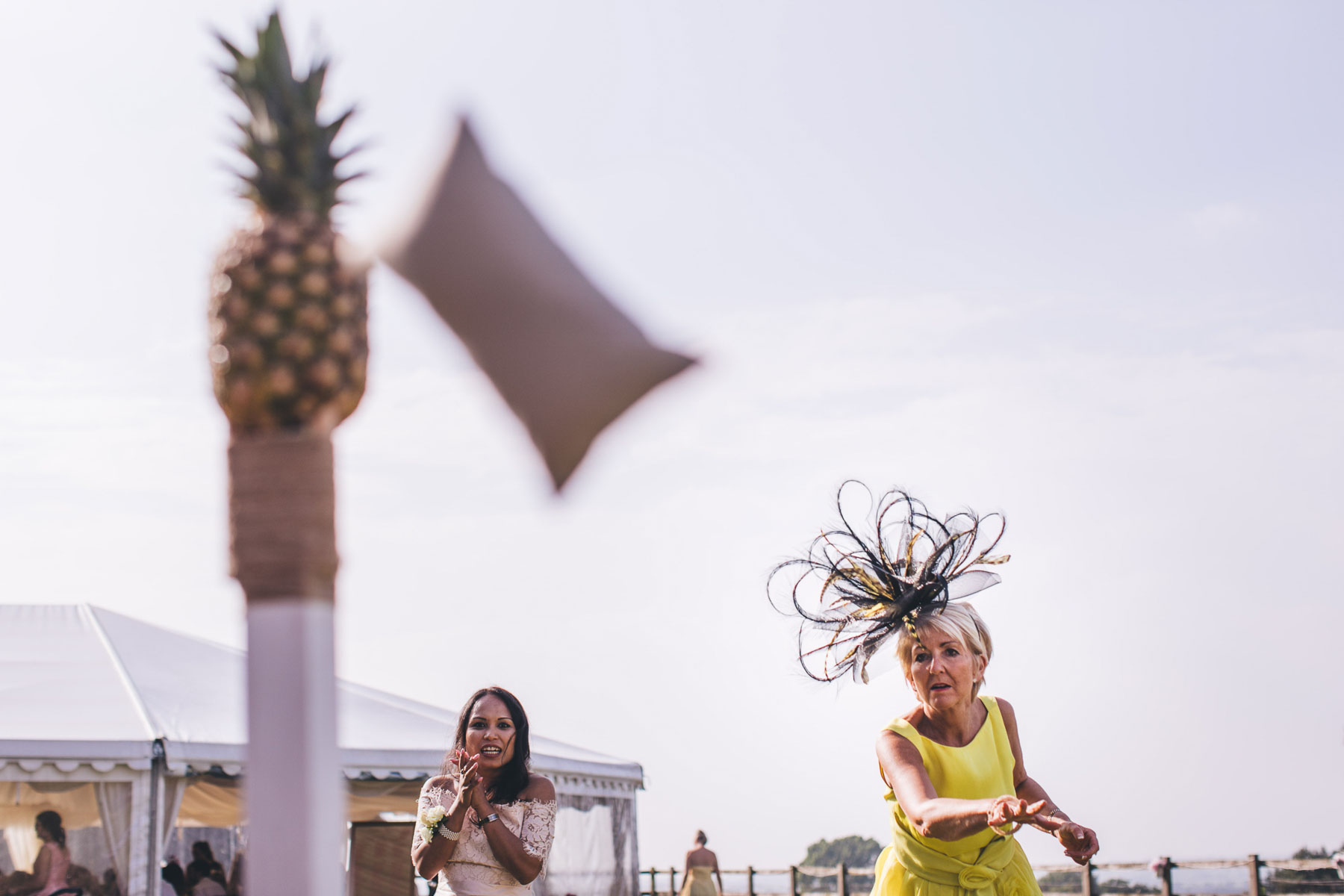 women throws sack at pineapple