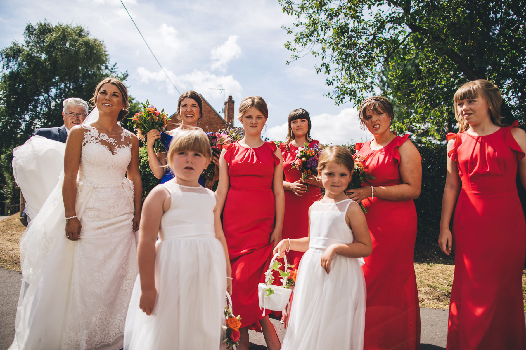 bride and her wedding party all wait to go into their ceremony