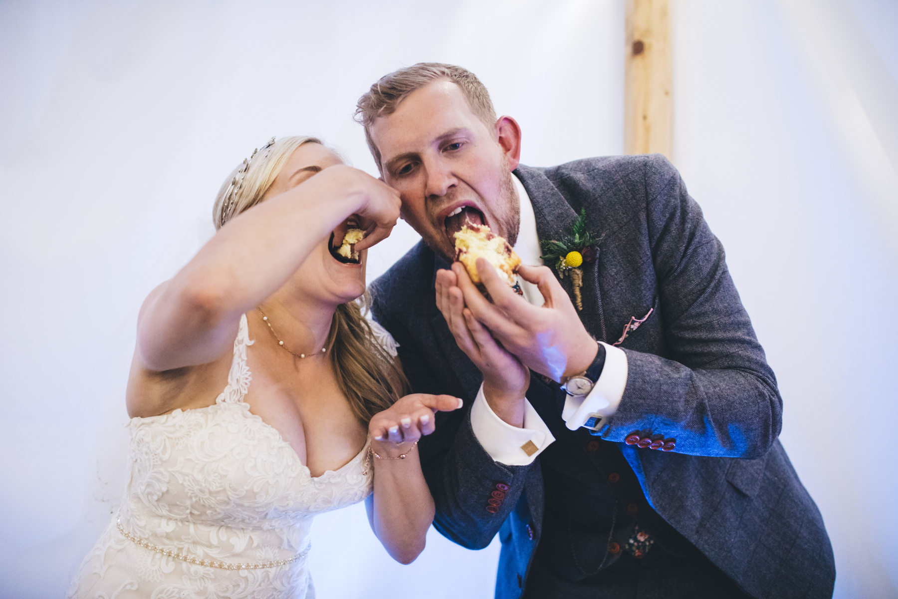 couple eat their wedding cake