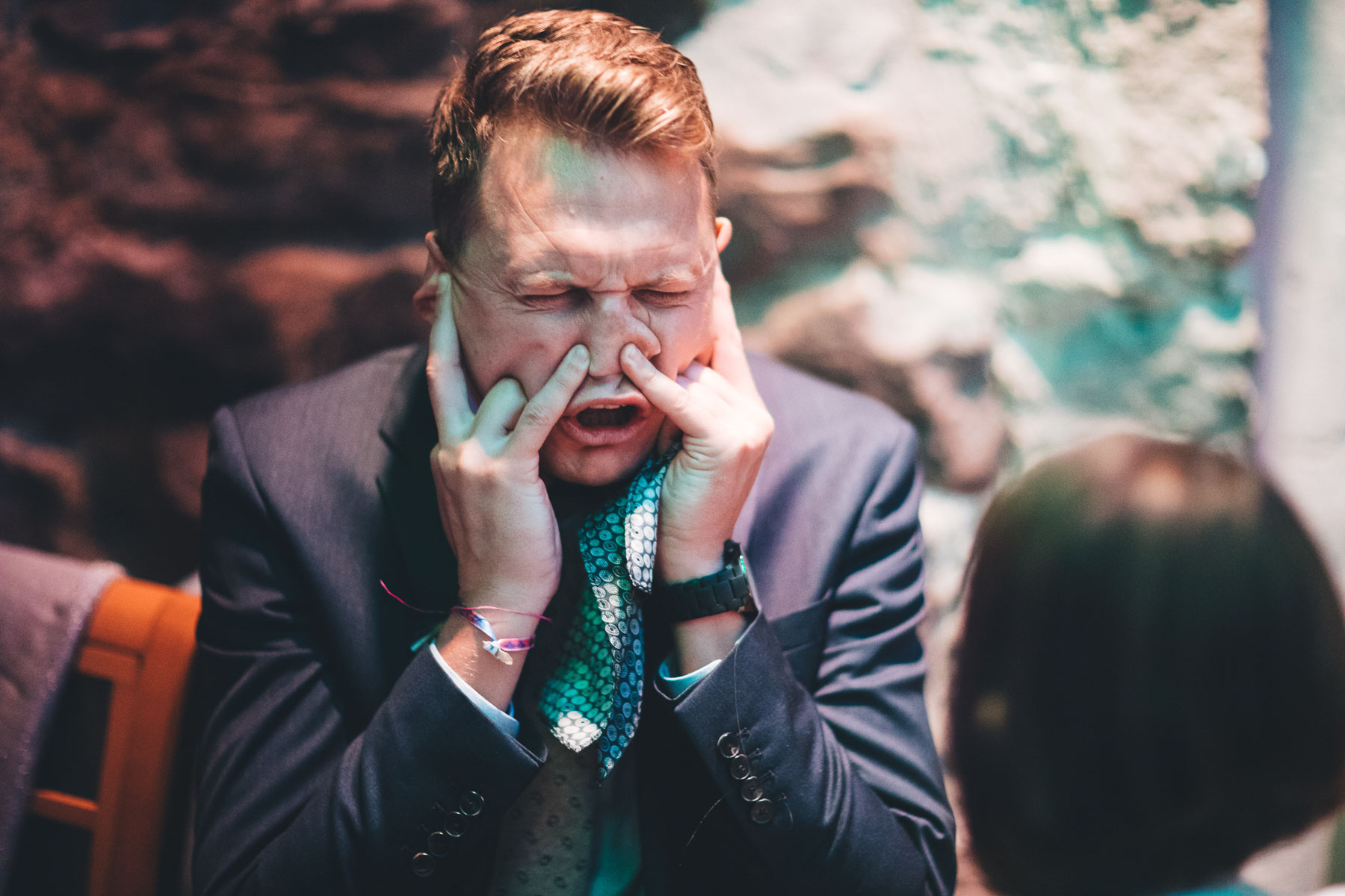 man pulls funny face during the wedding breakfast