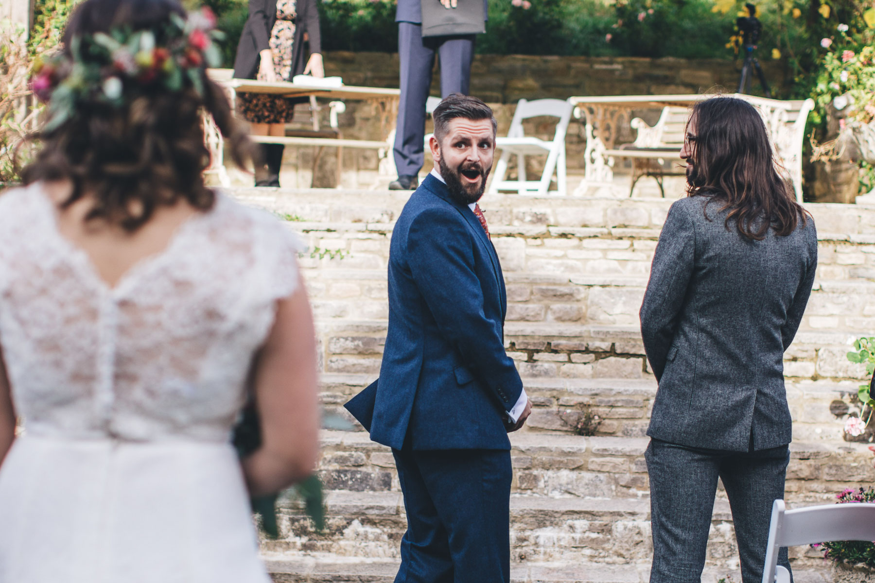 grooms shocked expression as he sees his bride come down the aisle