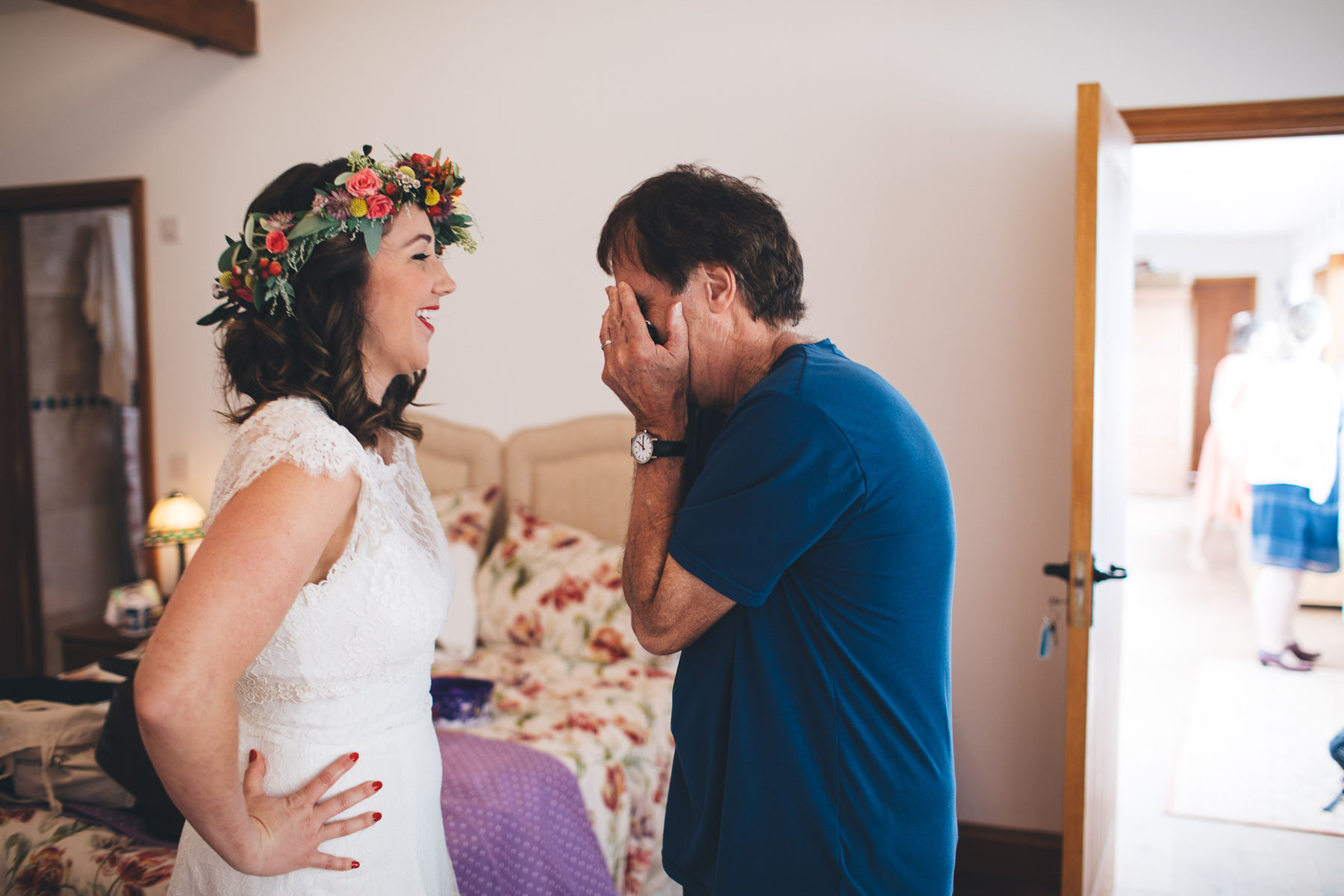 Dad covers his face in exasperation at seeing his daughter ready for her wedding