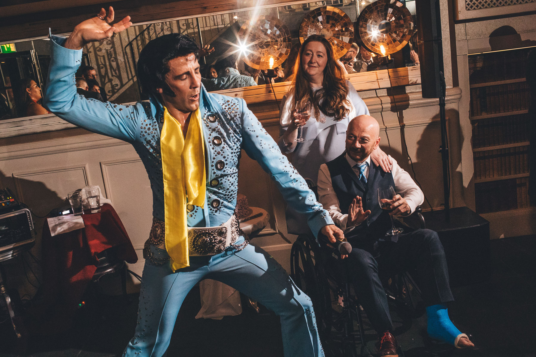 elvis performs in front of man in wheel chair