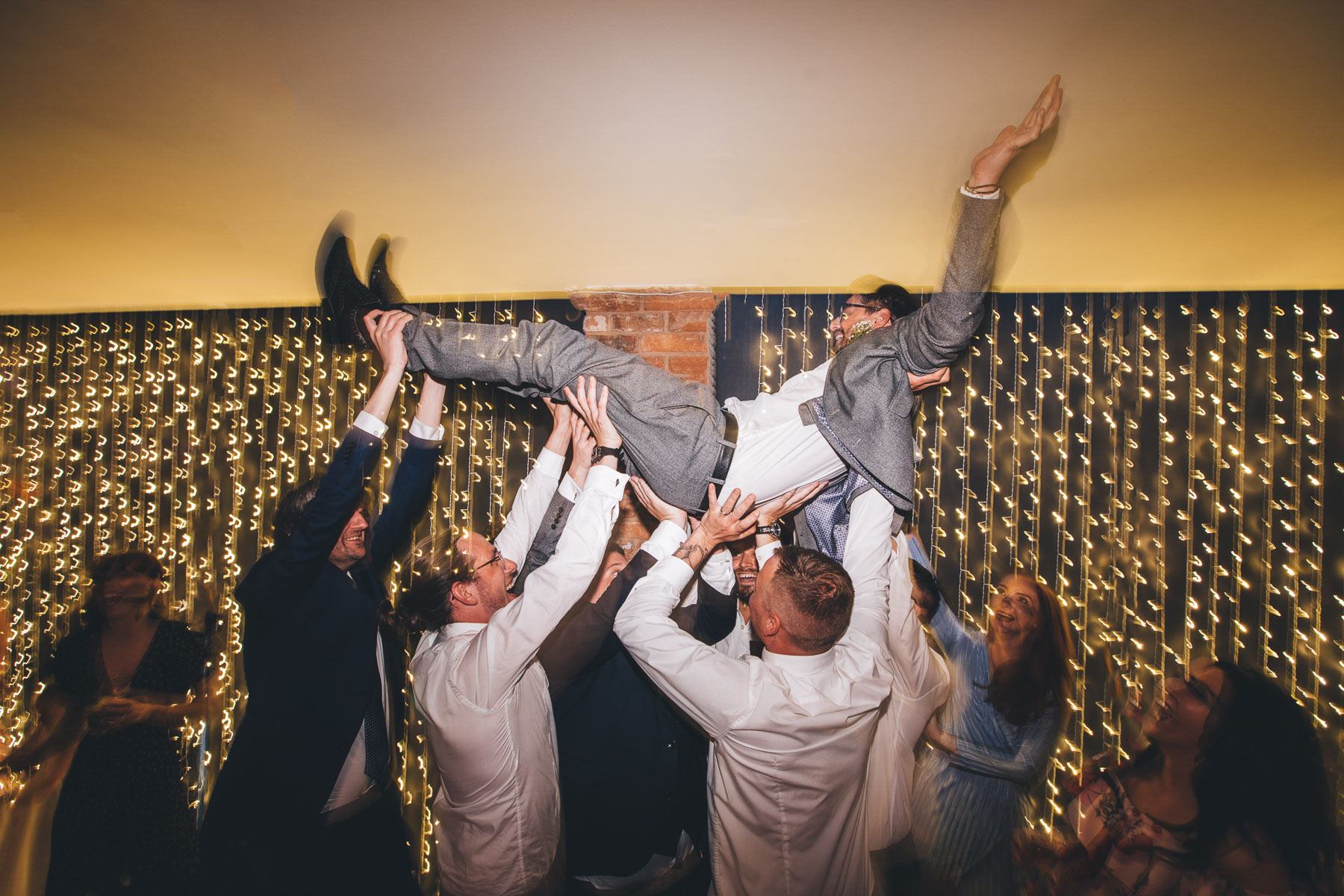 man raised up above everybody on the dance floor