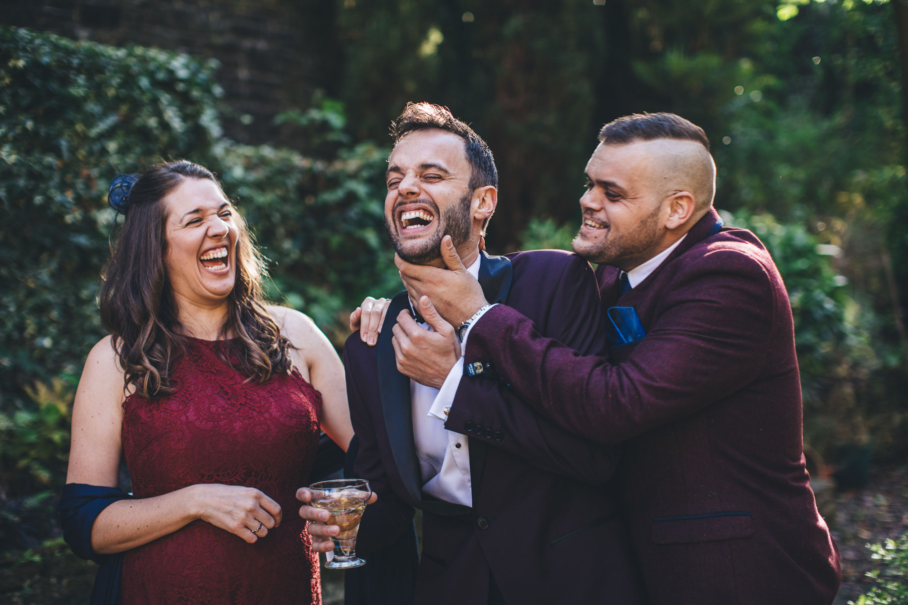 groomsmen and girls fall about laughing