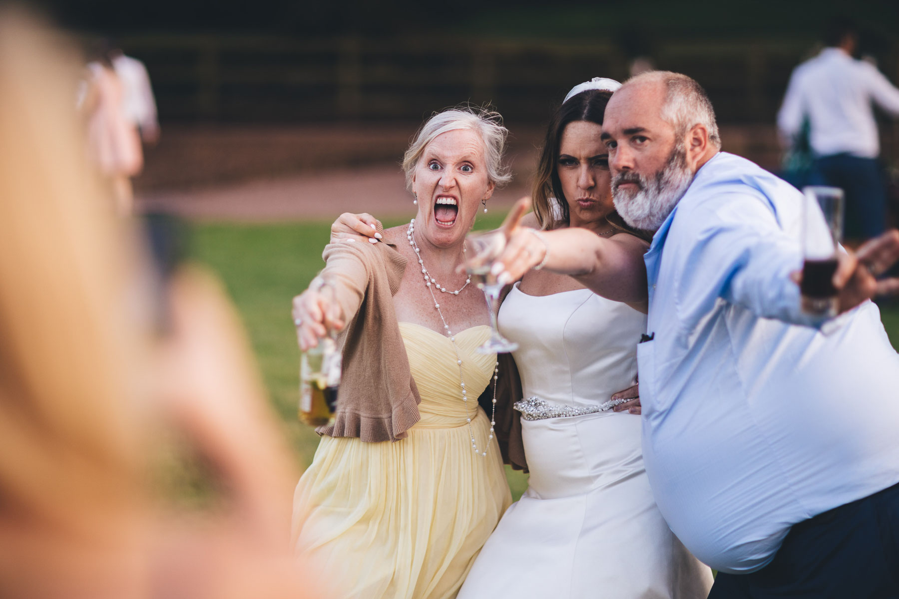 bride poses for a funny photo with her guests