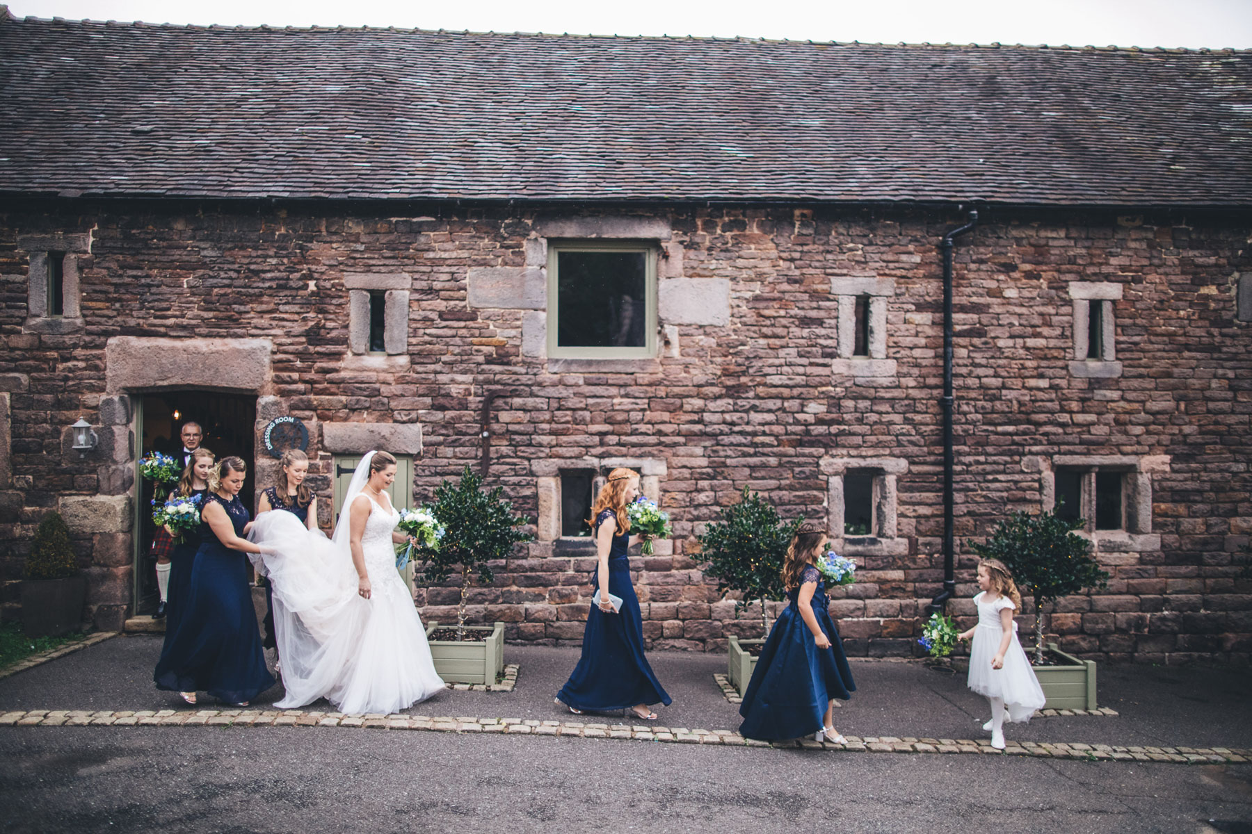 bride with her wedding party walking to the ceremony