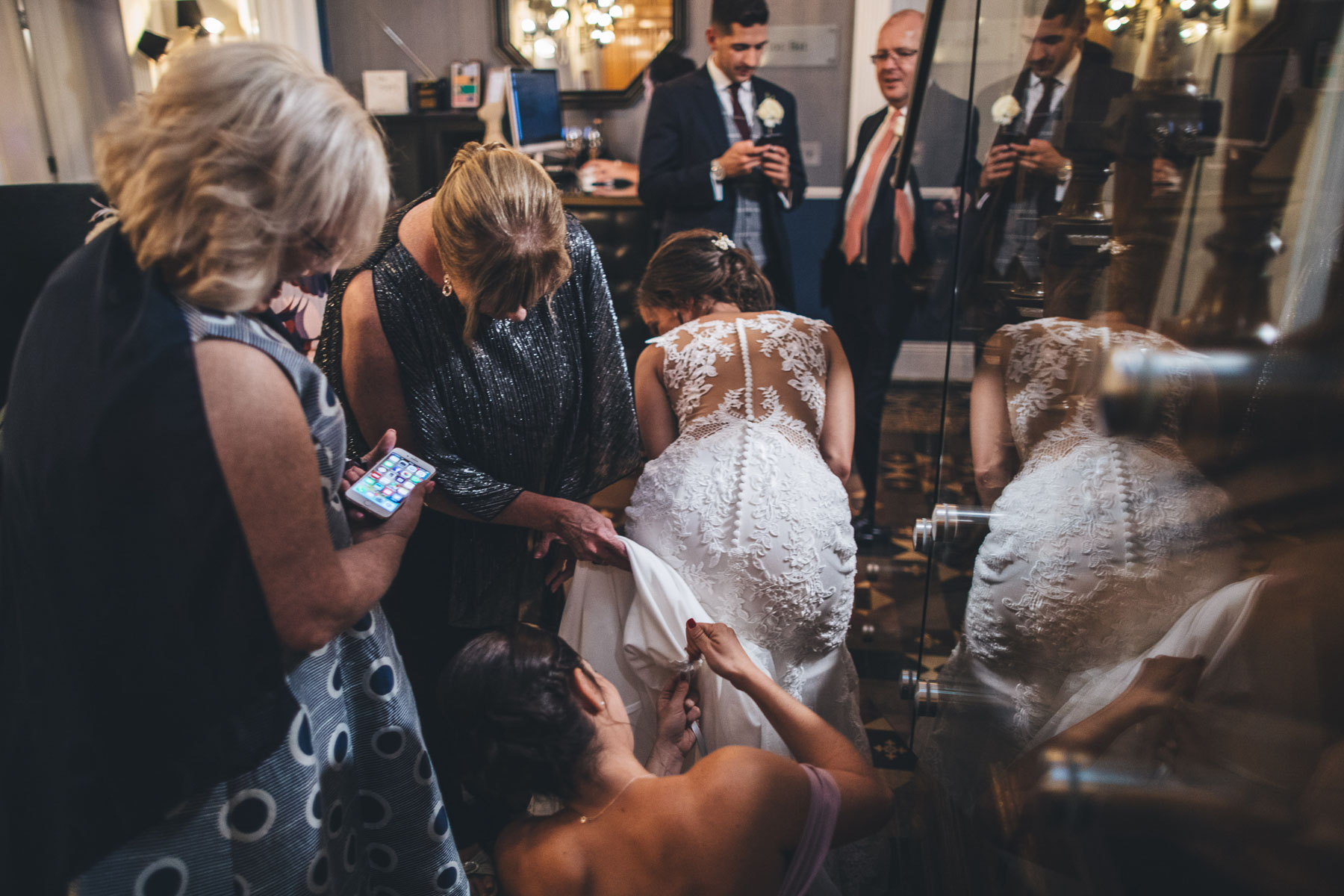 bridesmaid finding hook on the brides dress