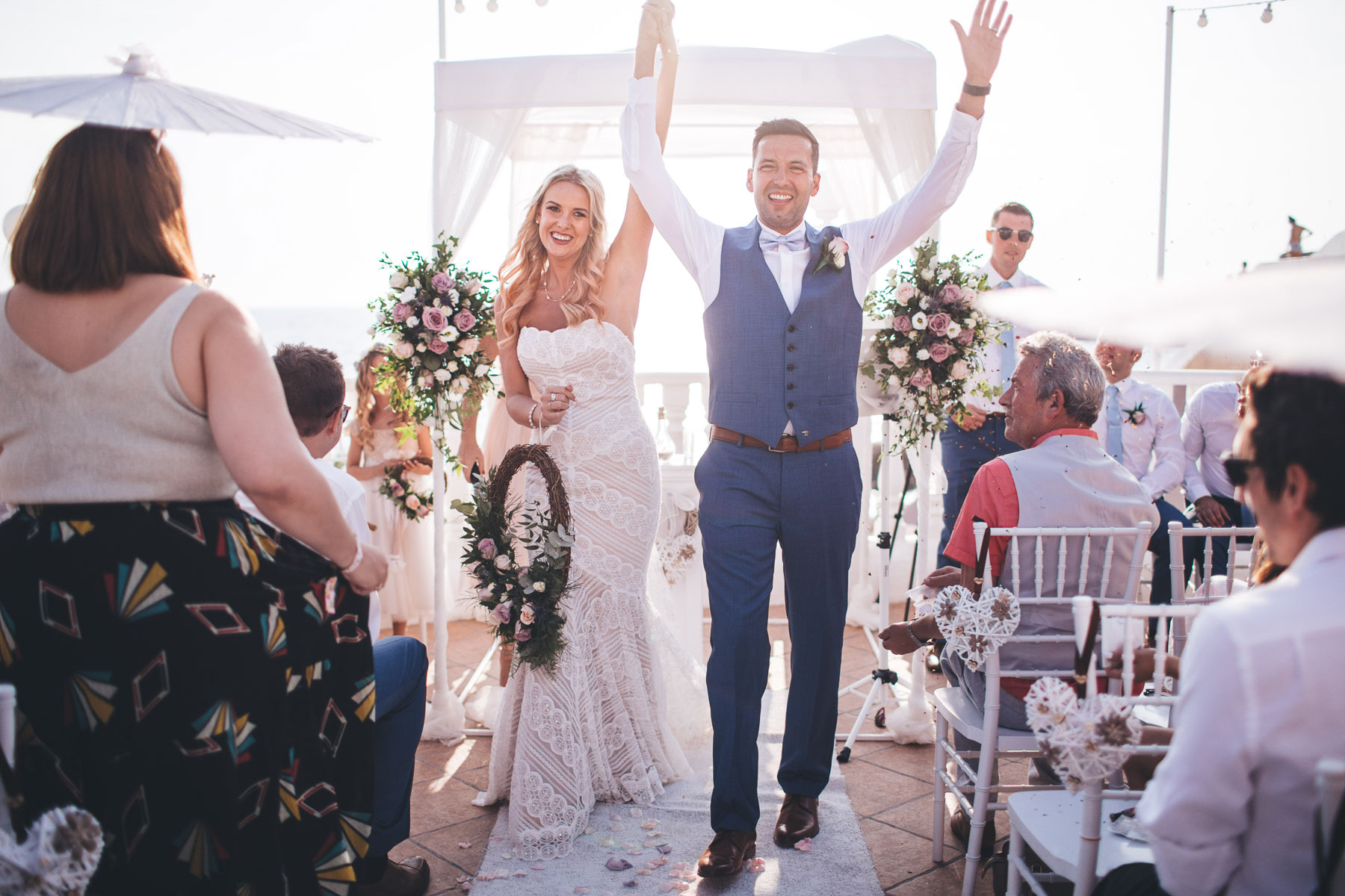 couple raise their arms in the ibiza wedding ceremony