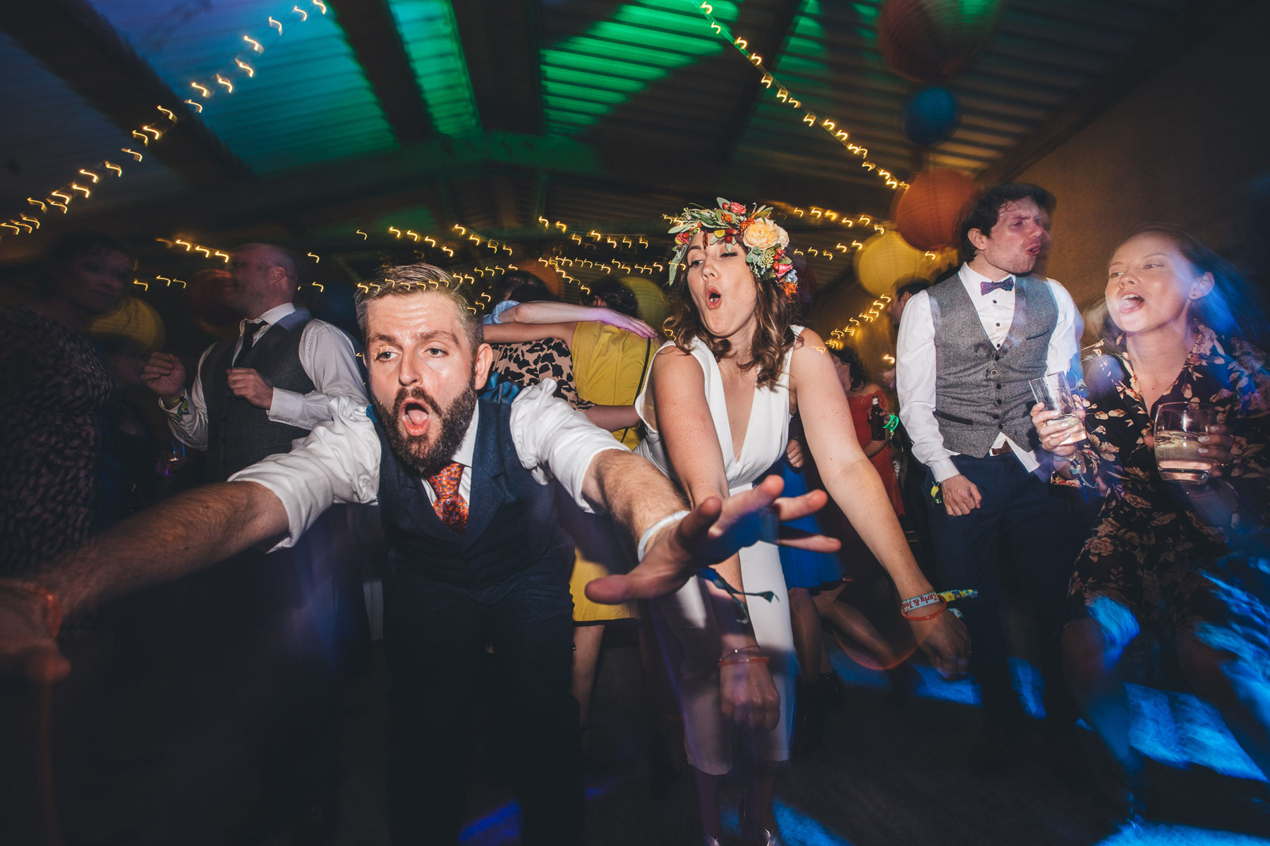 bride and groom dance to rolling in the deep stretched out forwards and mouths open