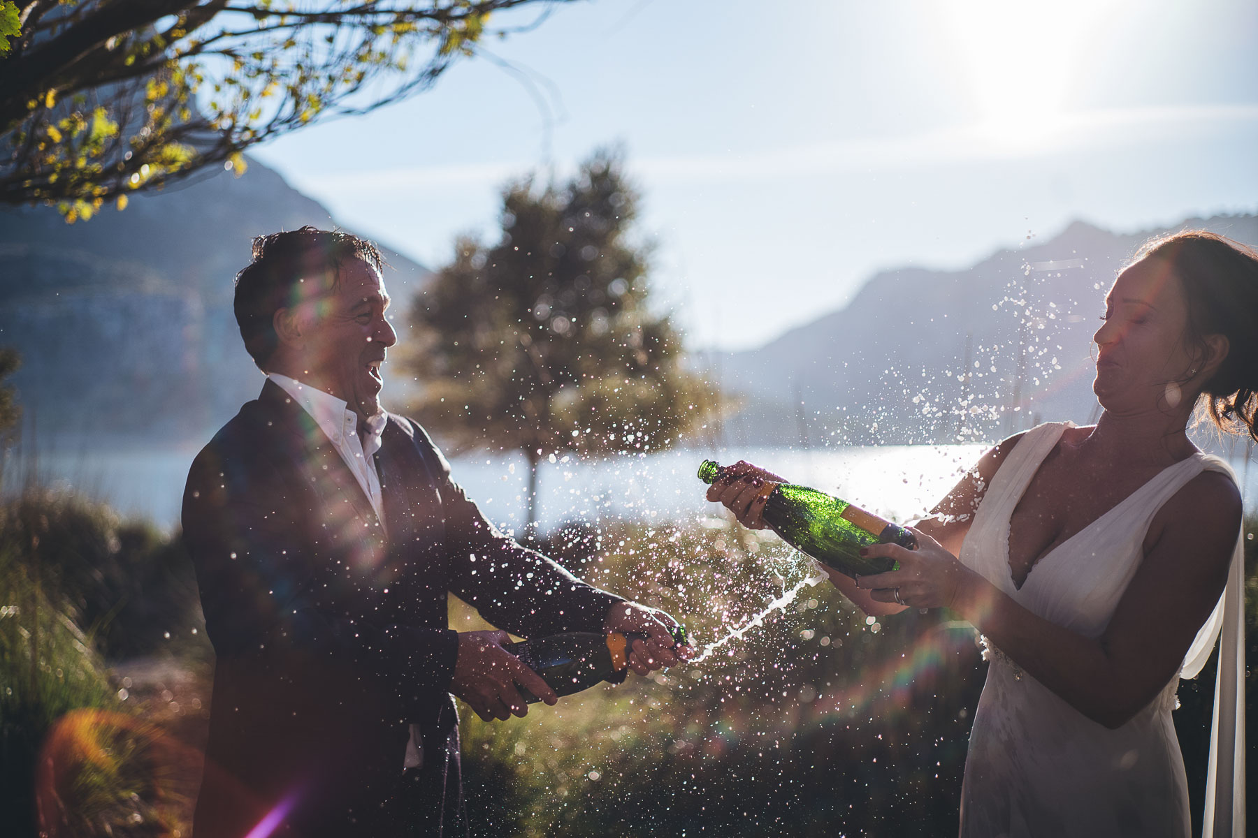 couple spray each other with champagne