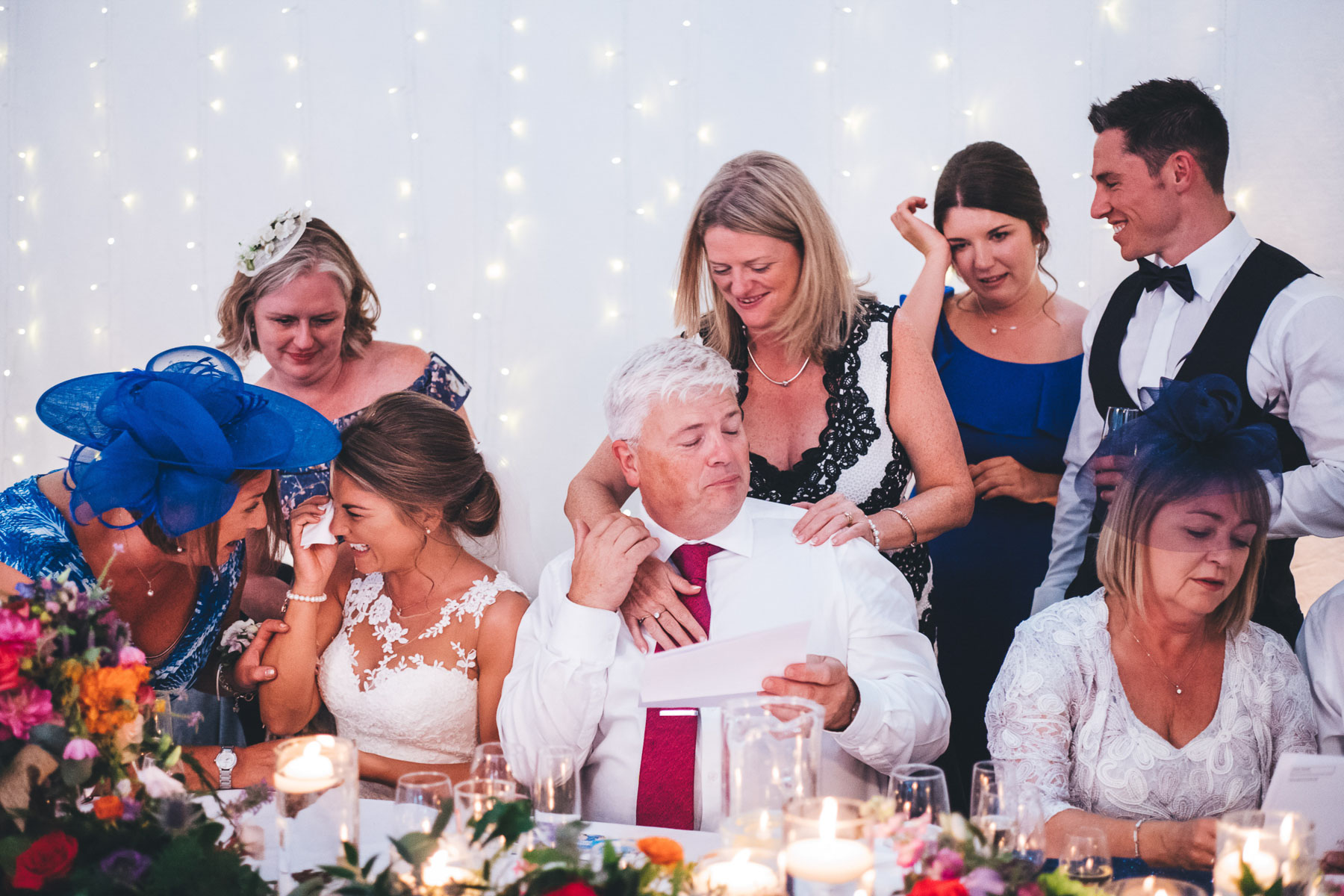 tableau of wedding party getting emotional after the speeches