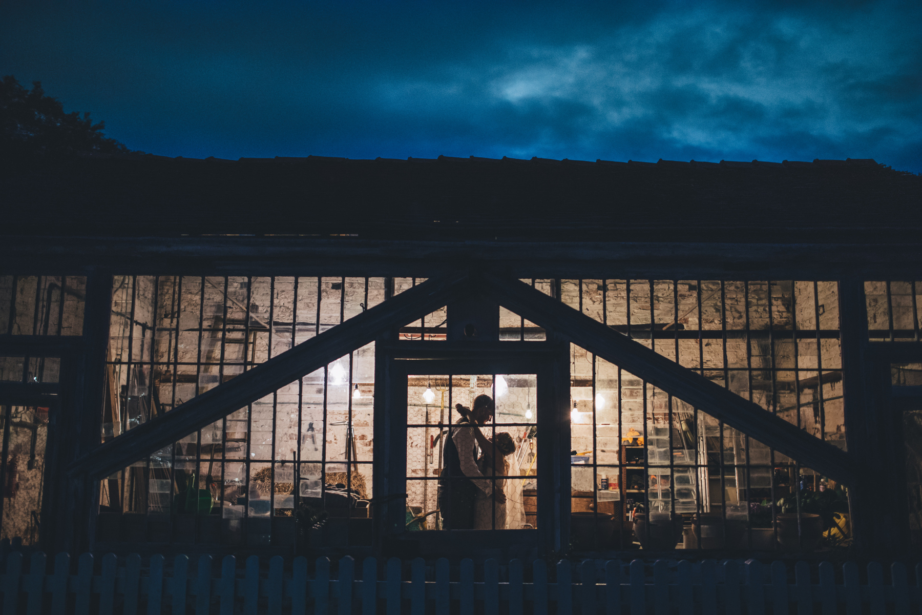 couple embrace in potting shed at dorfold hall wedding