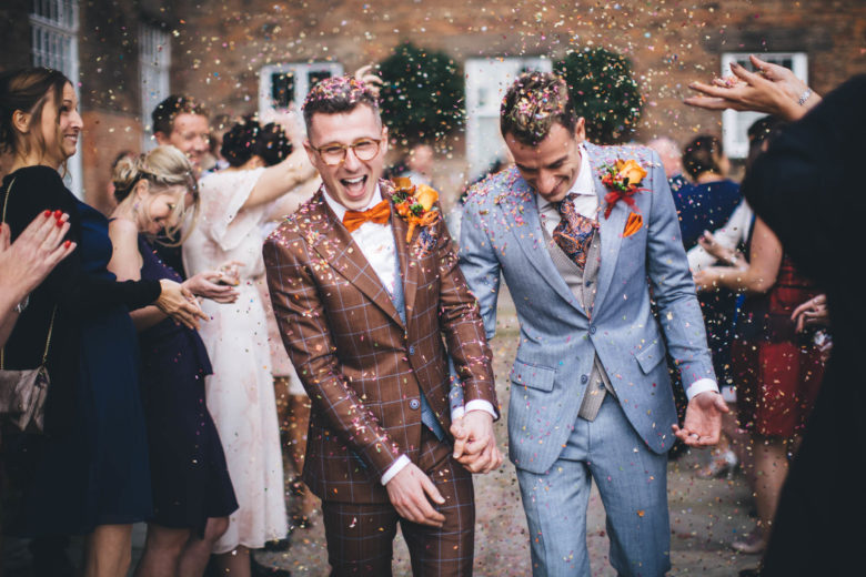 gay wedding confetti moment in most excellent suits