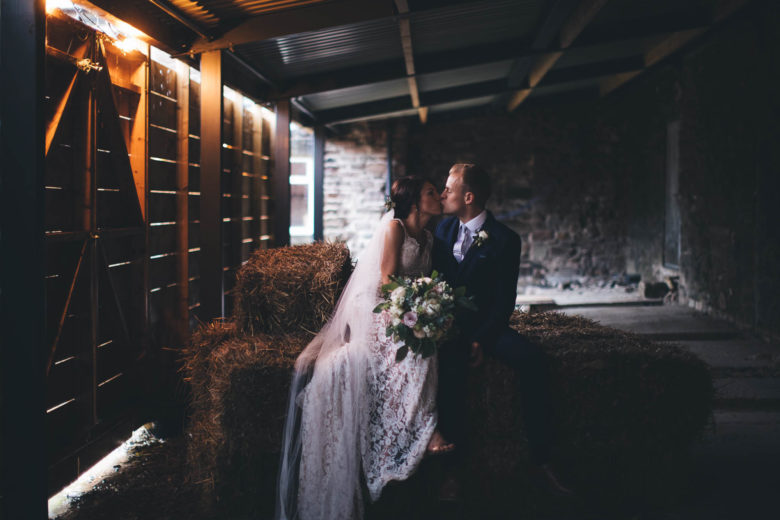 low light scene in barn of couple getting close