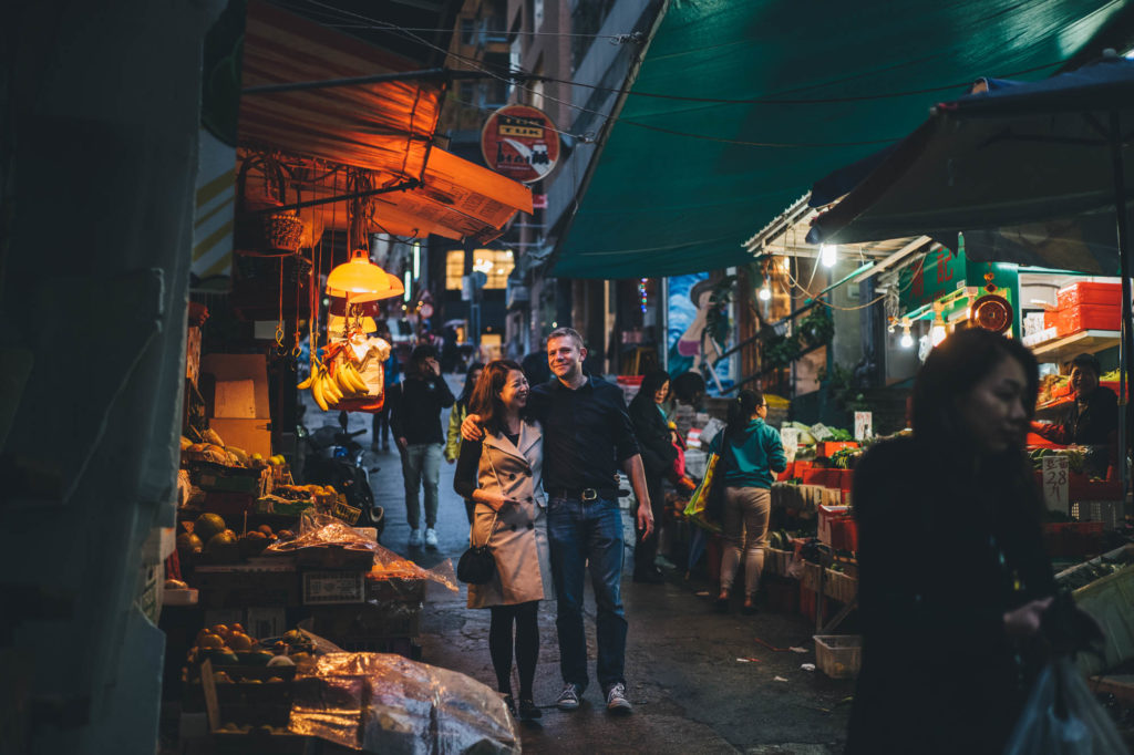 lovers walk through hong kong together