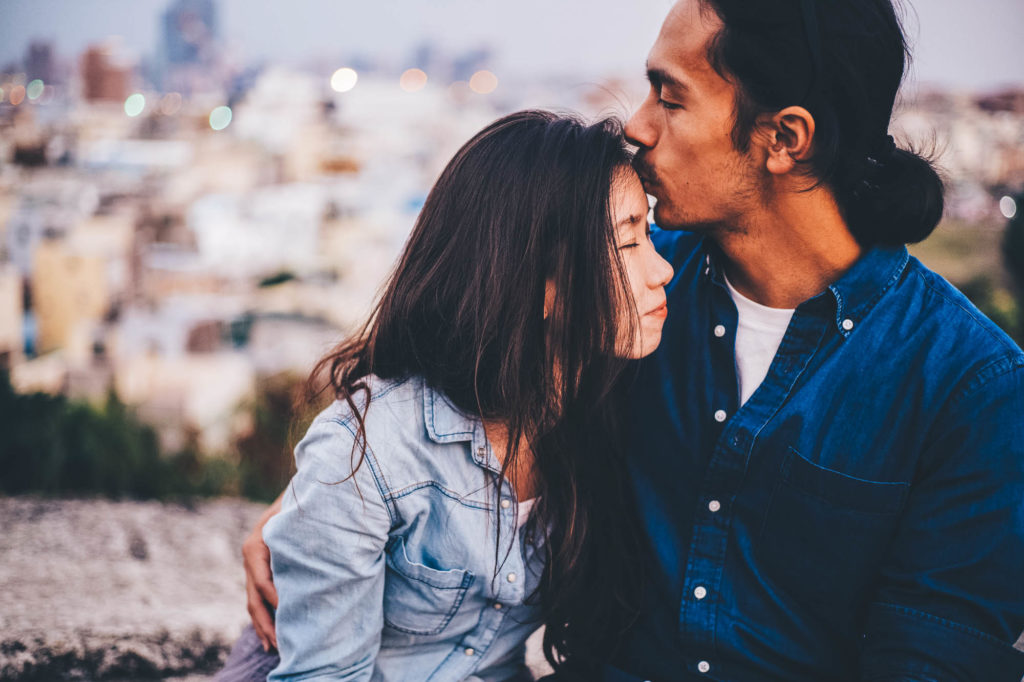 boyfriend kissing girlfriend on the forehead