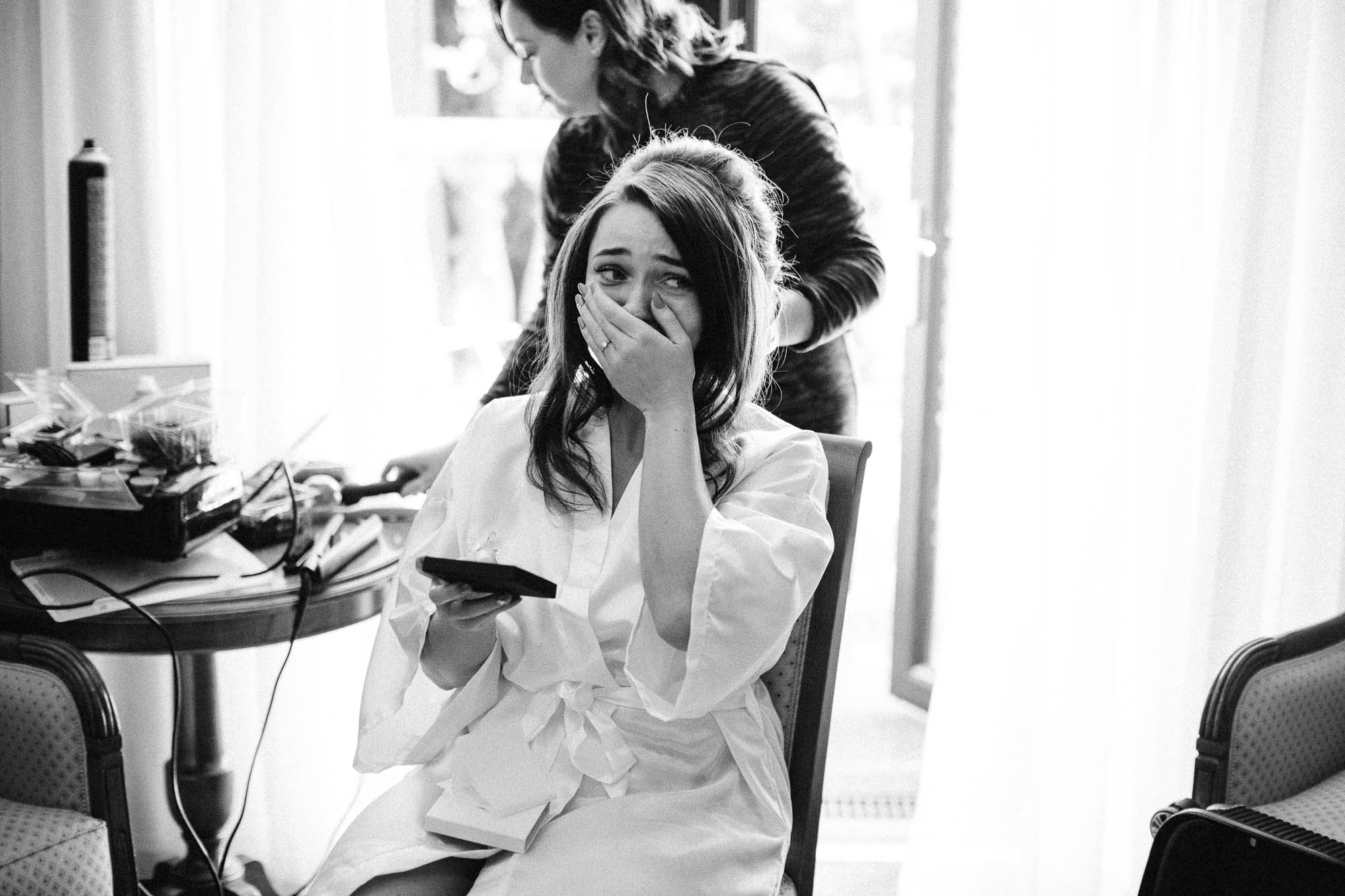 Bride covers her mouth but can't conceal her emotions on morning of wedding as she gets ready