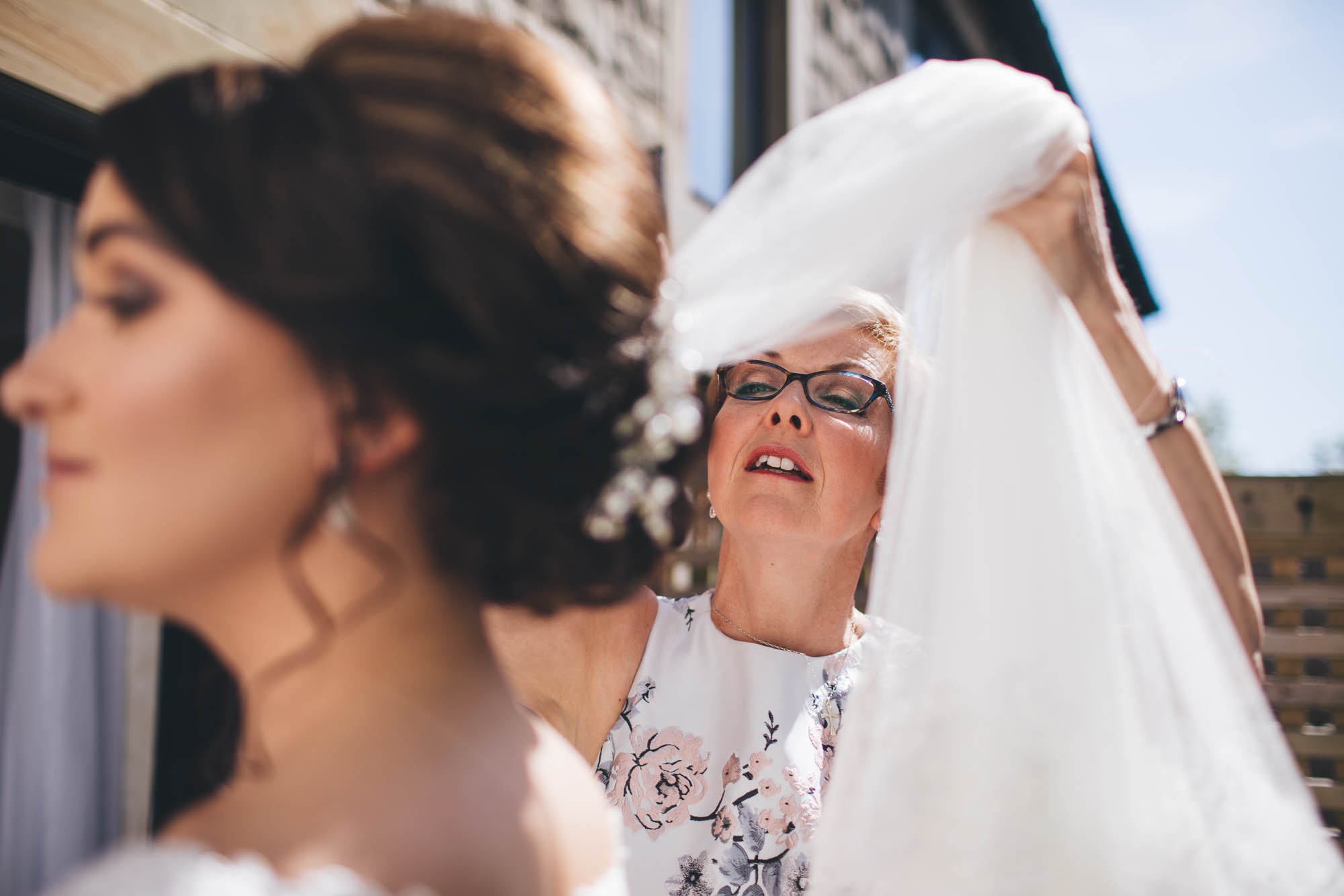Mother of Bride adjusts daughters veil on the morning of her wedding