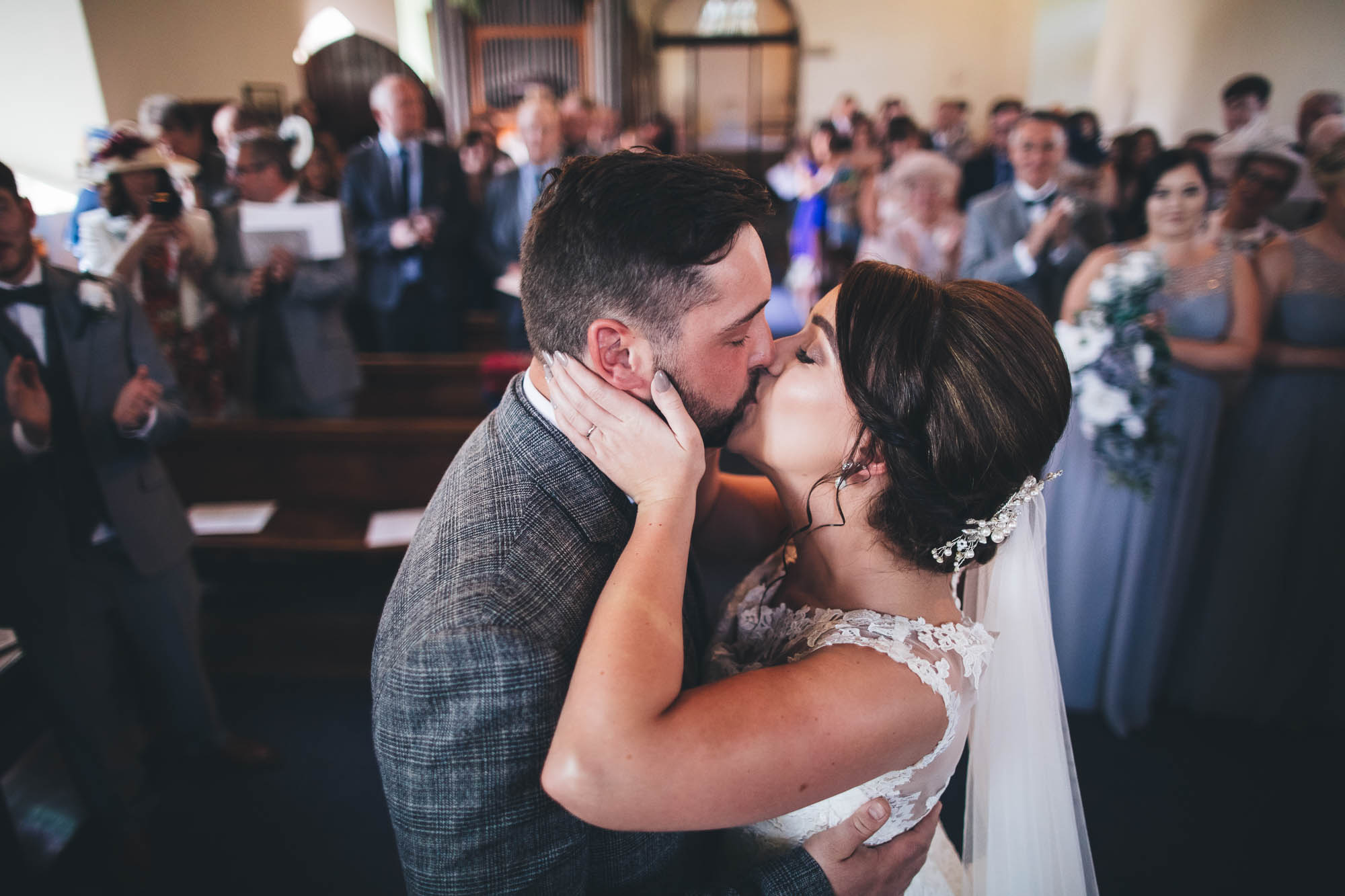 Bride and Groom share their first kiss in front of wedding guests at Wedding Ceremony