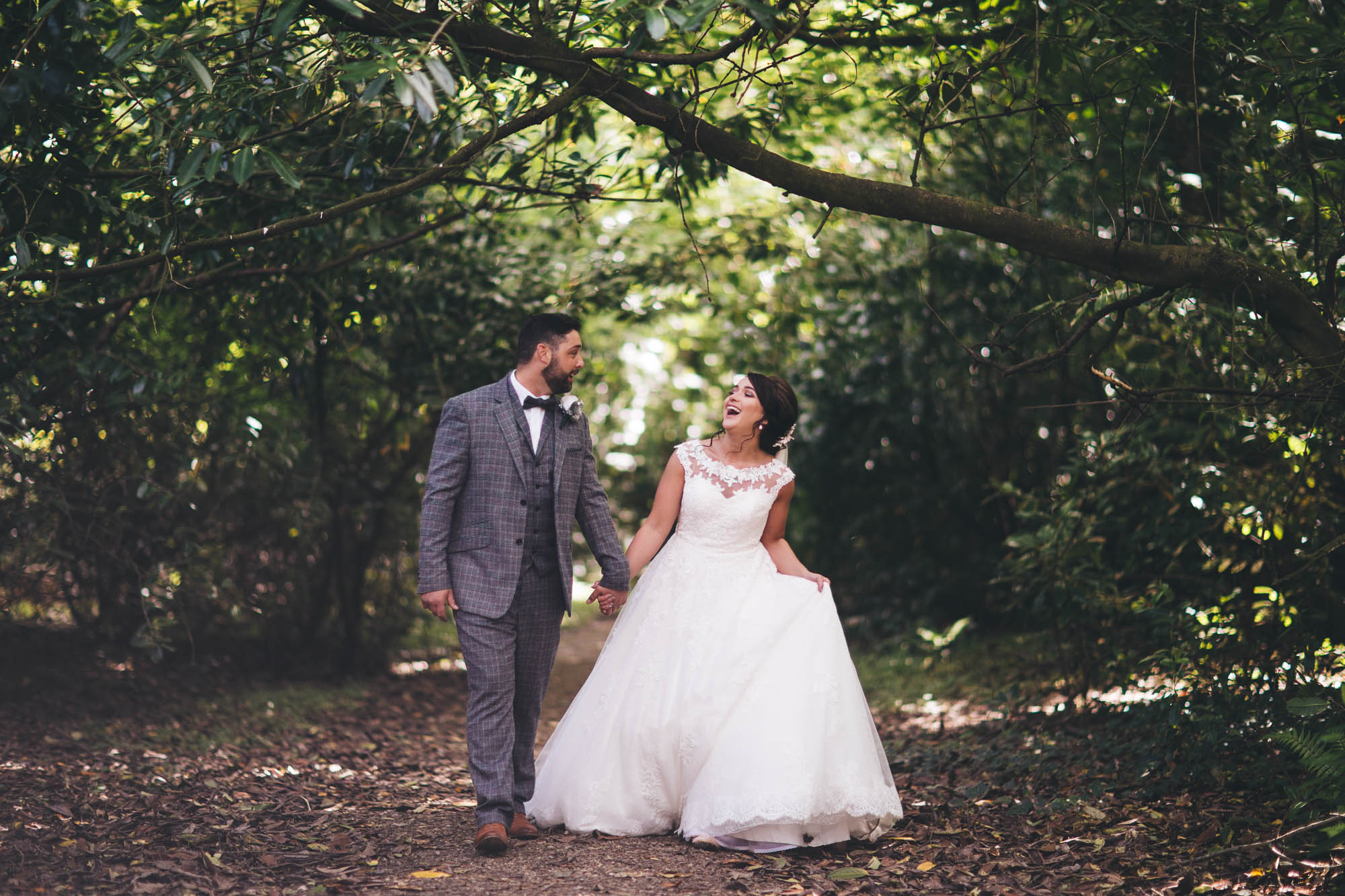 Newlyweds happily wander through the forest