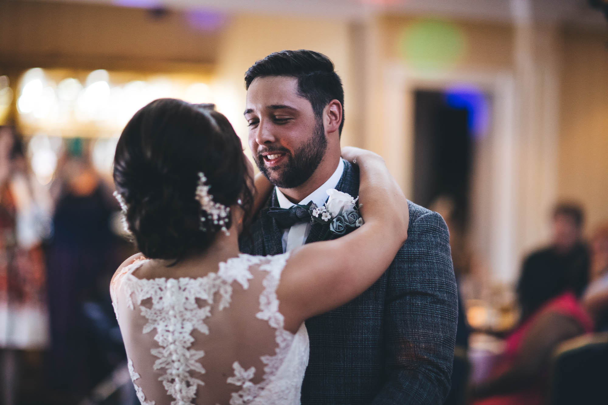 Groom looks into Bride's eyes lovingly as they share their first dance