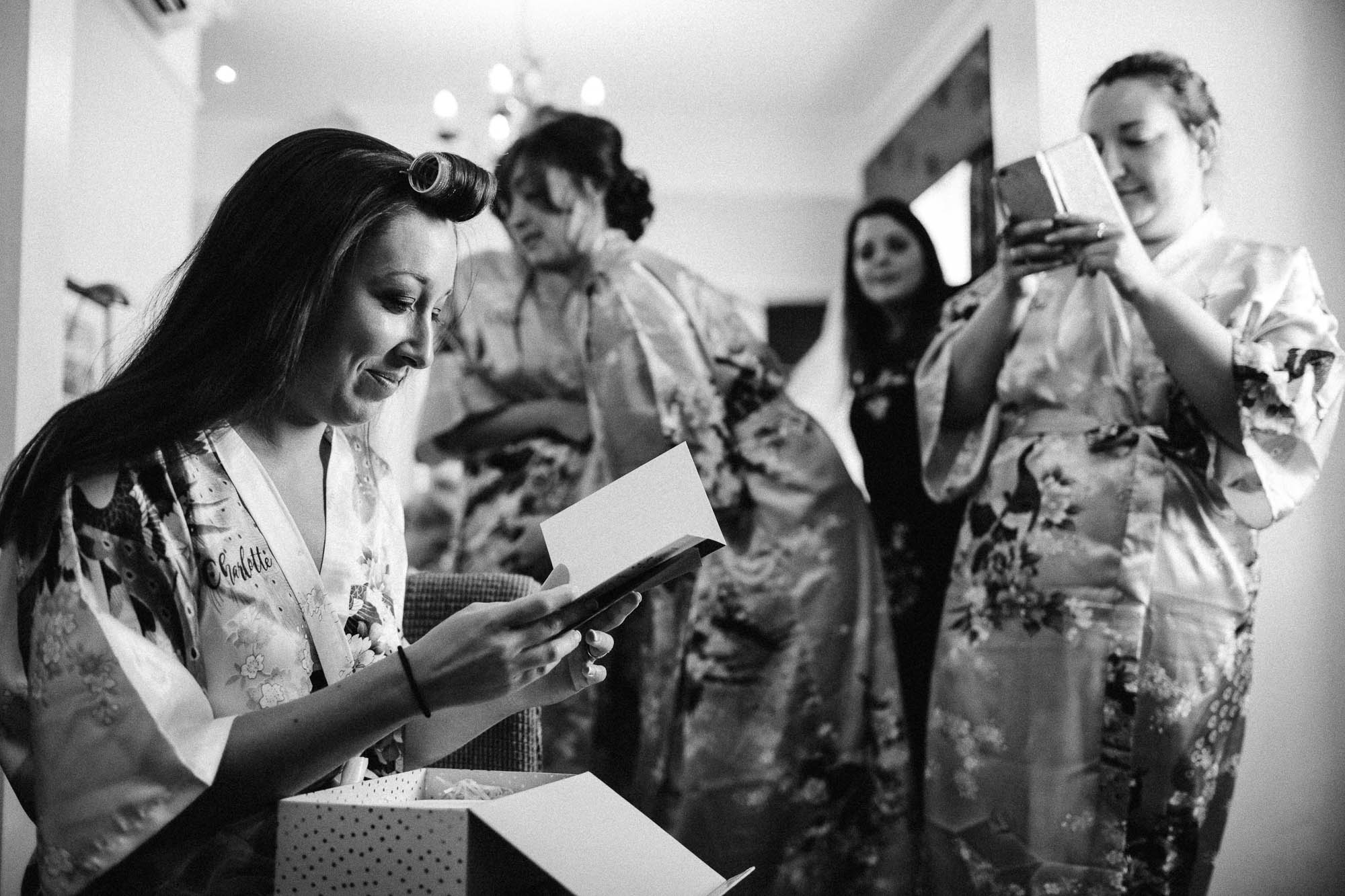 Bride opening gifts during bridal prep