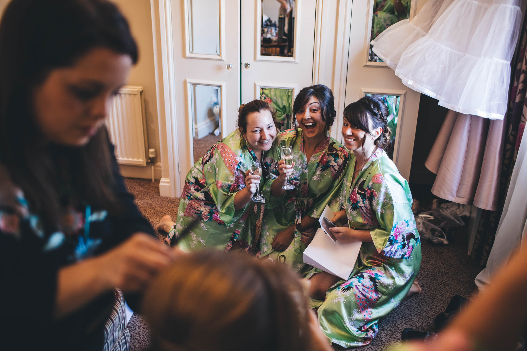 Bridesmaids pose for photo with bubbly during bridal prep