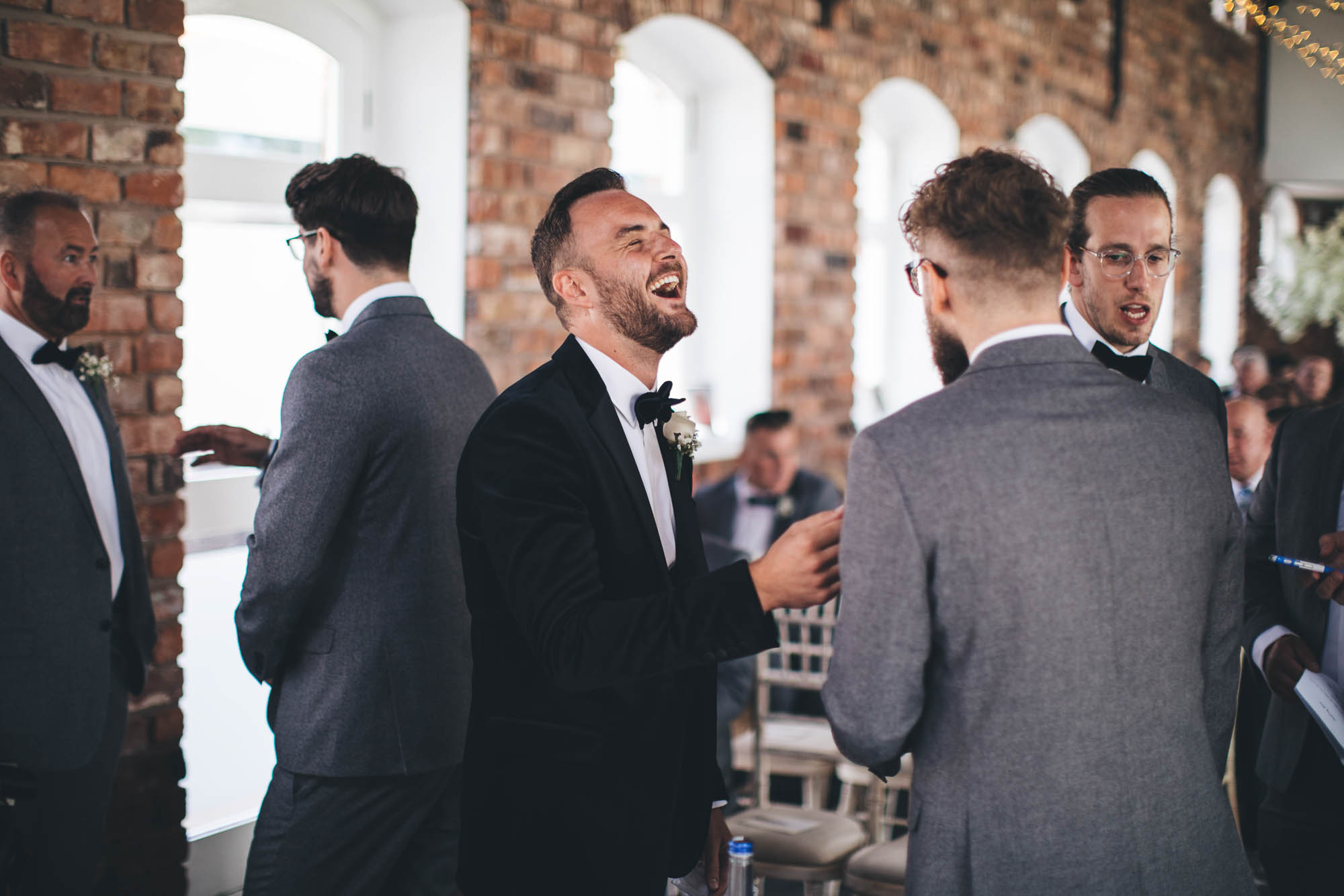 Groom laughing before wedding ceremony with Best Man and ushers
