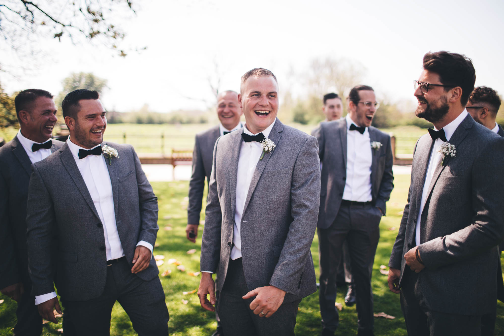 Groomsmen share a joke with each other