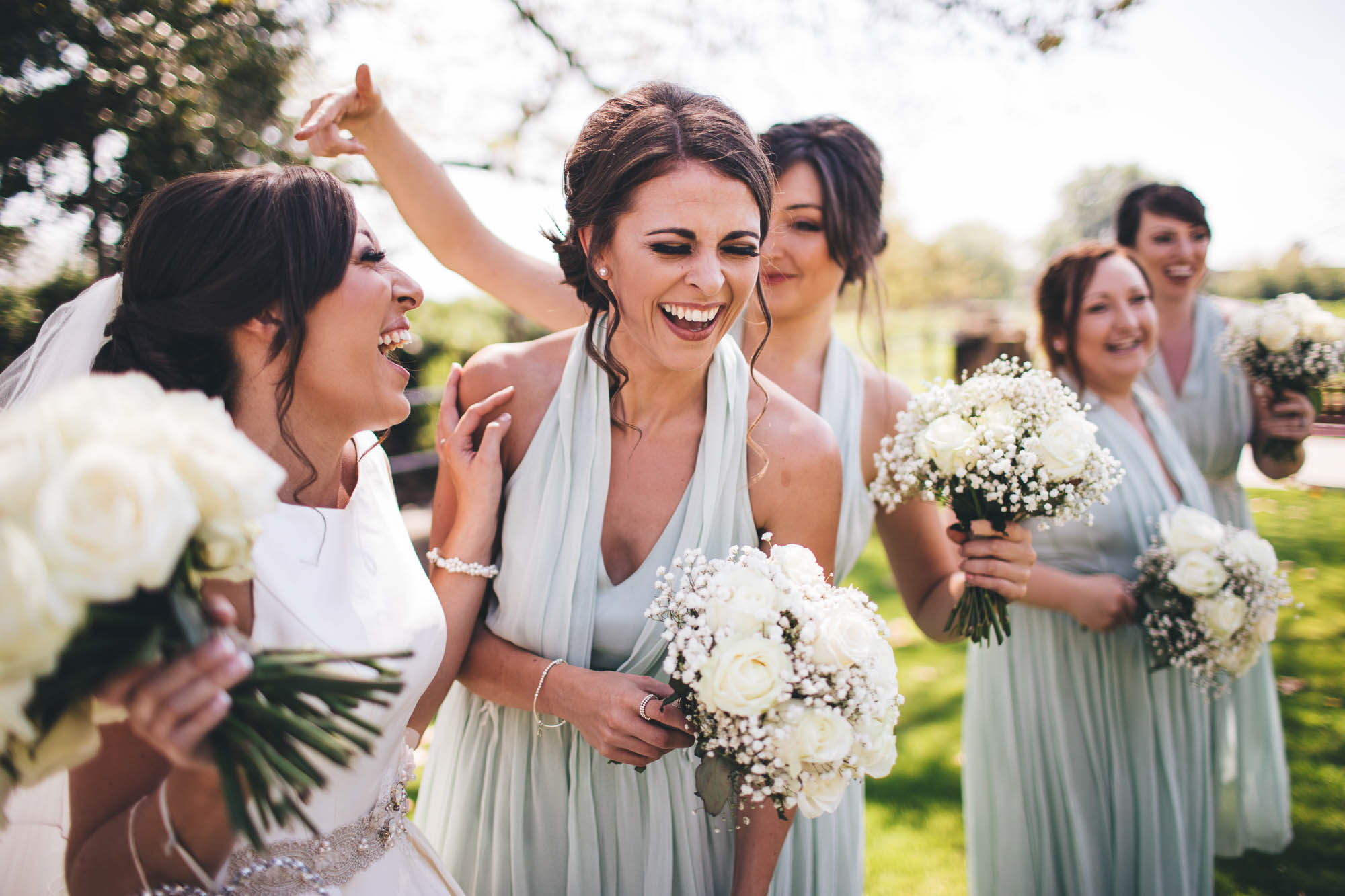 Bride shares a joke with her bridesmaids