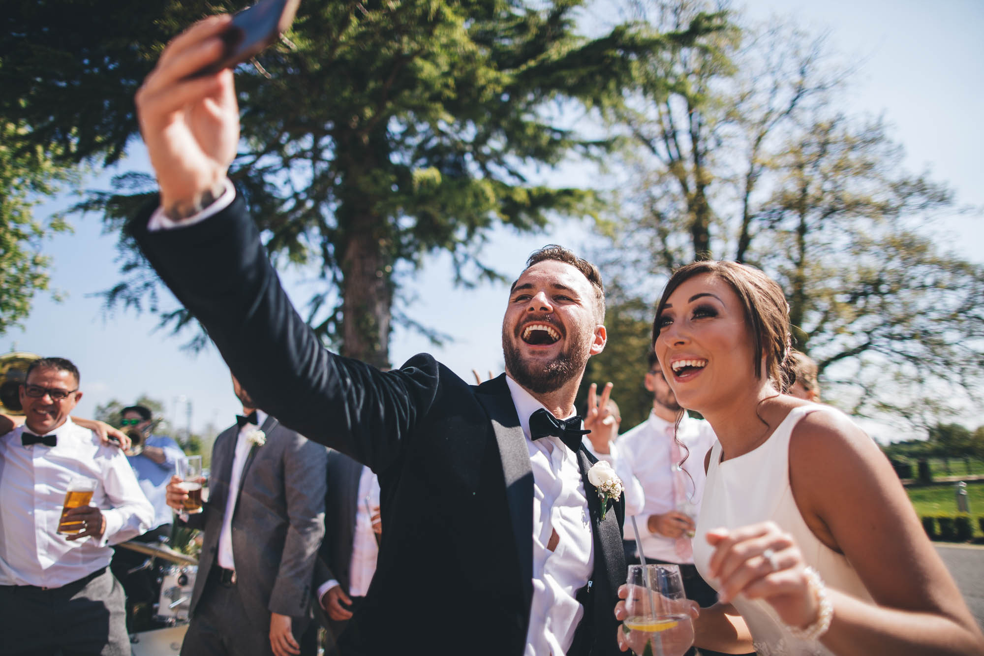 Wedding couple take a quick selfie outside after getting married