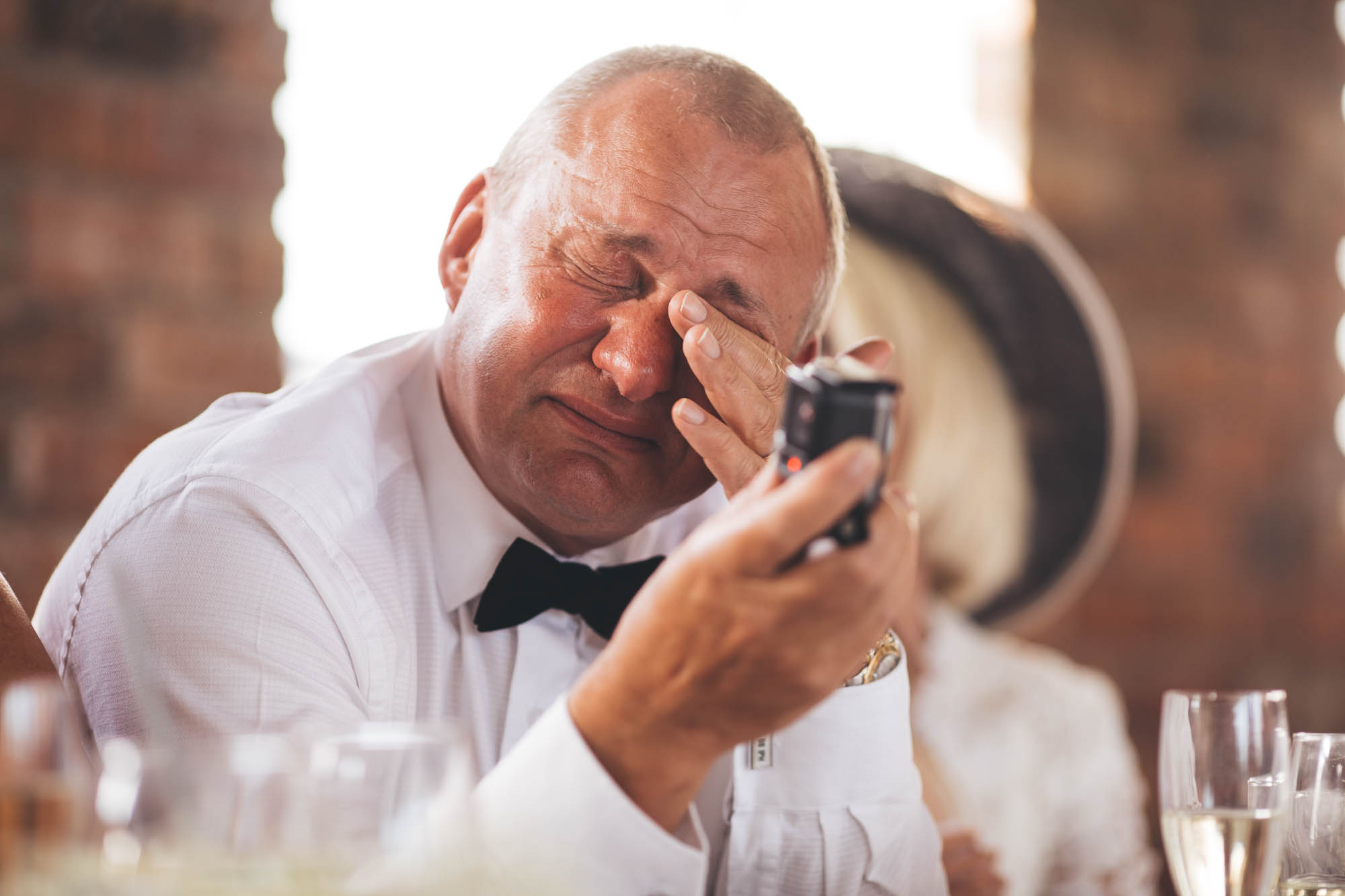 Father of the Groom wipes away his tears