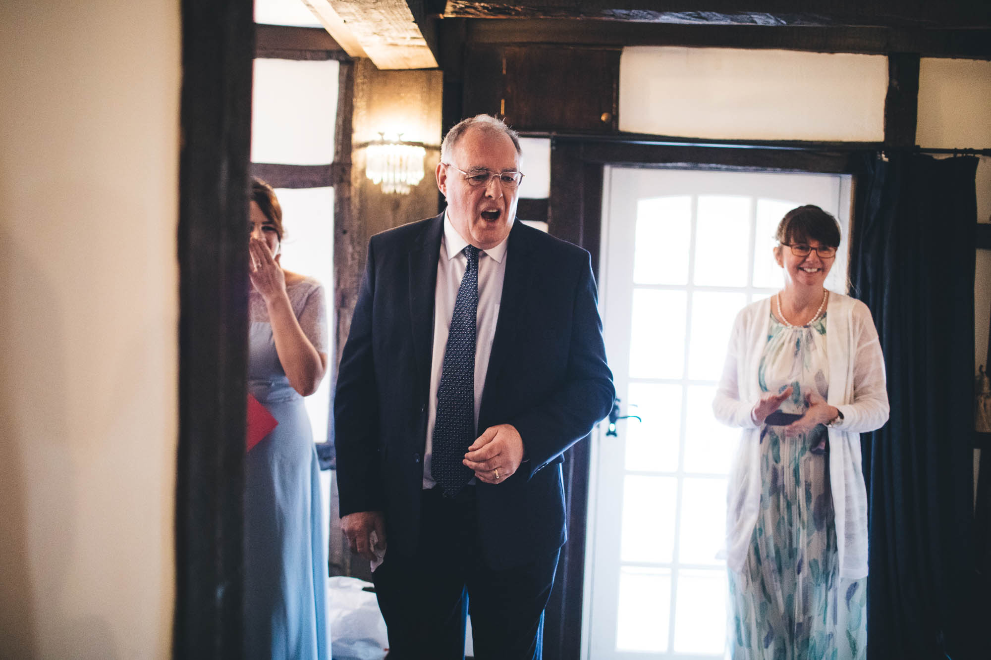 Father of Bride looks shocked as he sees bride for first time in wedding dress