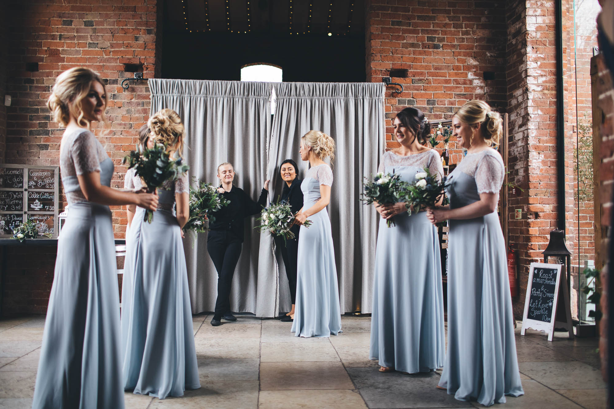 Bridal party talk with staff members as they wait for Bride to arrive