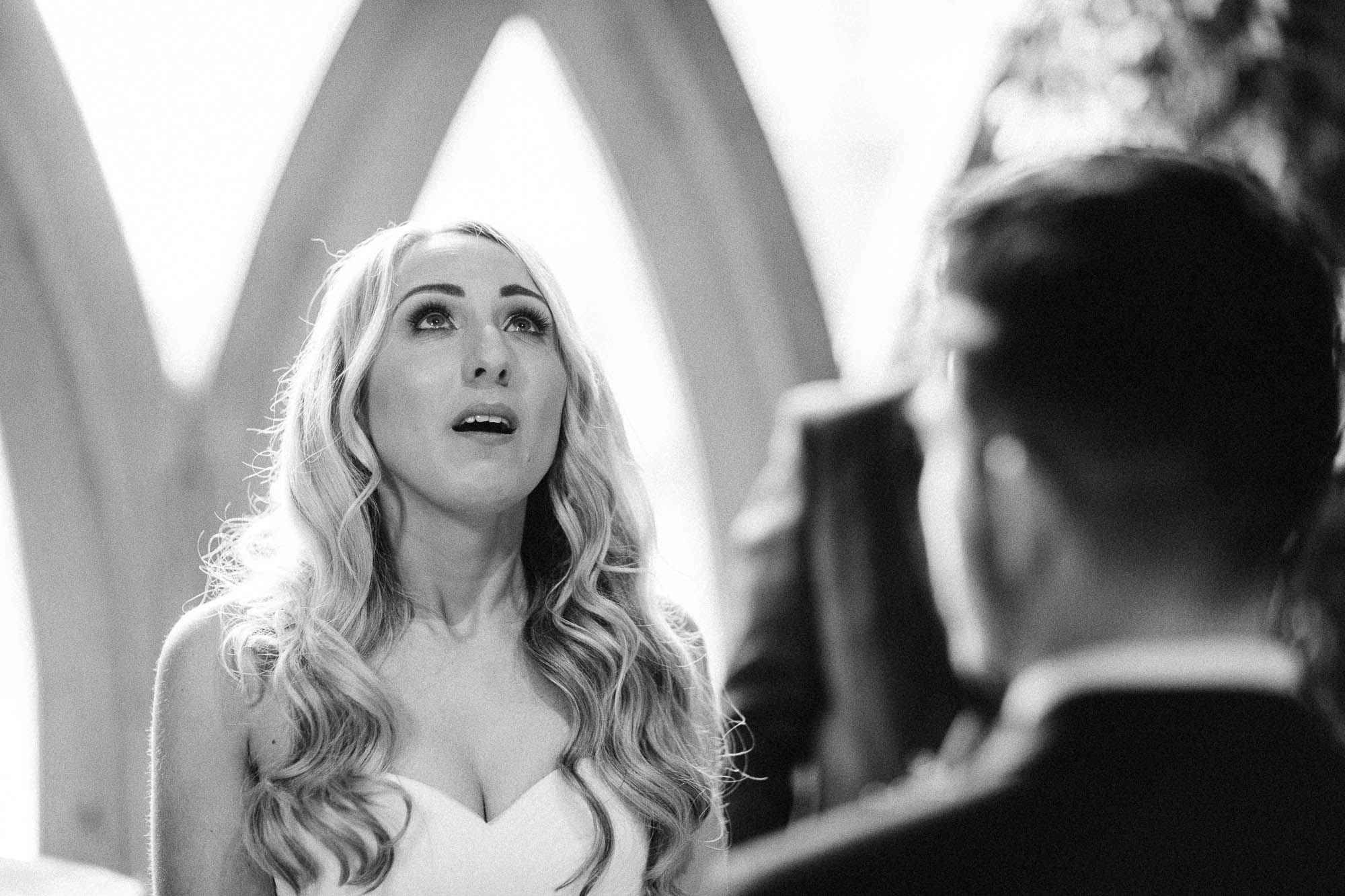 Black and white shot of Bride getting emotional saying her vows